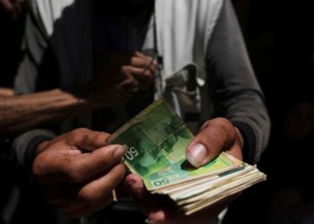 Cash is scarce in Gaza. Palestinians are paying a high price to get it