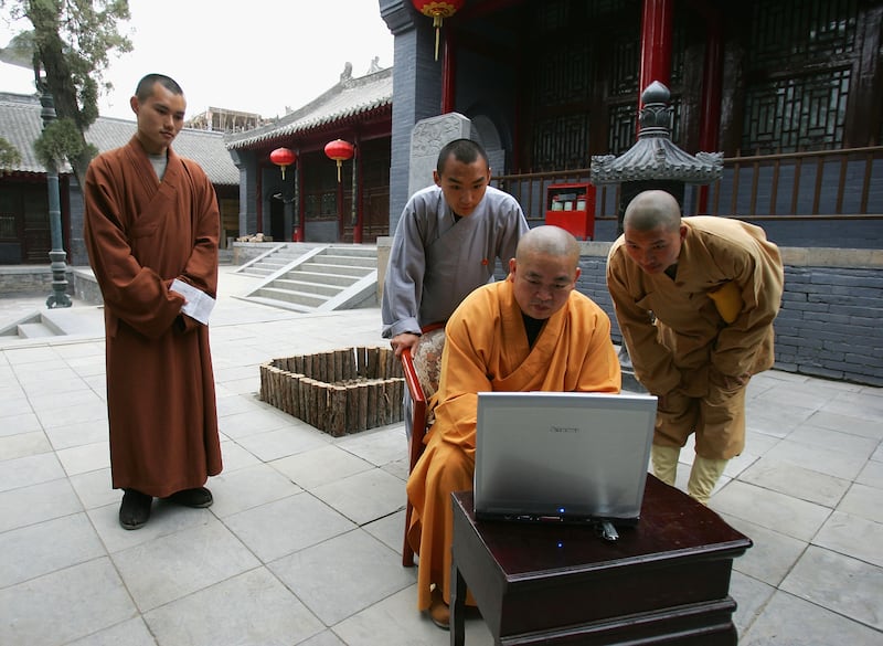 DENGFENG, CHINA - APRIL 8:  Shi Yongxin, abbot of the Shaolin Temple, works on the computer April 8, 2005 in Dengfeng, Henan Province, China. Shaolin Temple was built in AD 495 in the period of the Northern and Southern Dynasties (420-581), located in the Songshan Mountain area, and is the birthplace of the Shaolin Kung Fu. Shaolin Kung Fu, with its incredible strength, vitality and flexibility, is expecting to be included in the UNESCO intangible heritage list. Shi Yongxin sends his monks abroad to coach foreign students and has toured around the world lecturing on Buddhism and the Kung Fu spirit of his temple. Yongxin has led his warrior monks to more than 20 countries, including the United States, the United Kingdom and Japan. The Shaolin Temple now has overseas branches in London, Berlin, Budapest and Vienna.  (Photo by Cancan Chu/Getty Images)