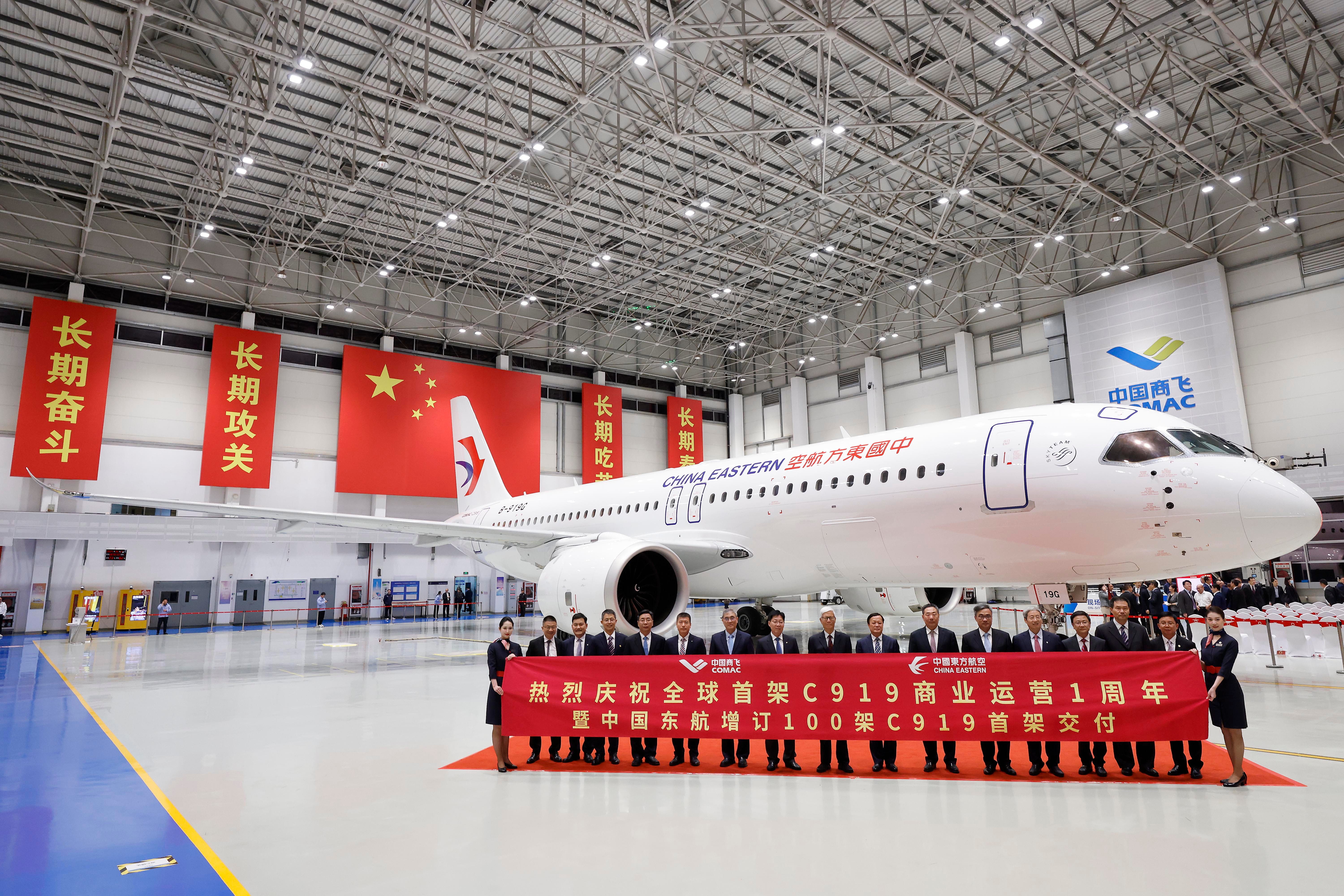 People pose for a photo with C919 passenger plane on May 27, 2024 in Shanghai, China.