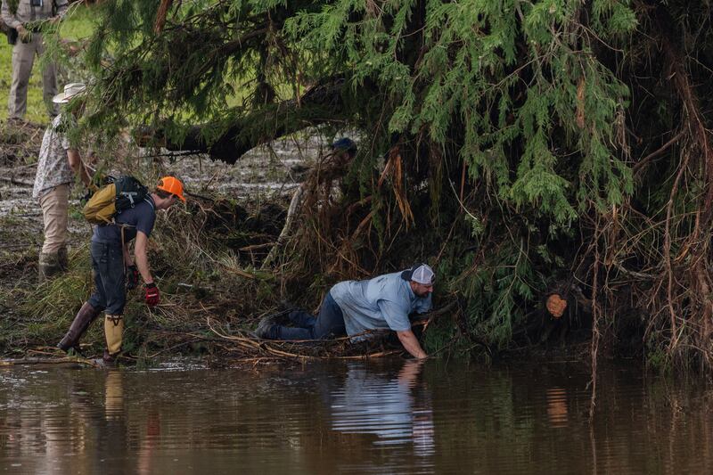 Search and recovery workers dig through debris looking for any survivors or remains of people swept up in the flash flooding near Camp Mystic on July 6, 2025 in Hunt, Texas.