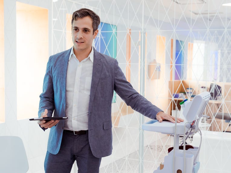 Dr. David Stark standing over a medical machine.