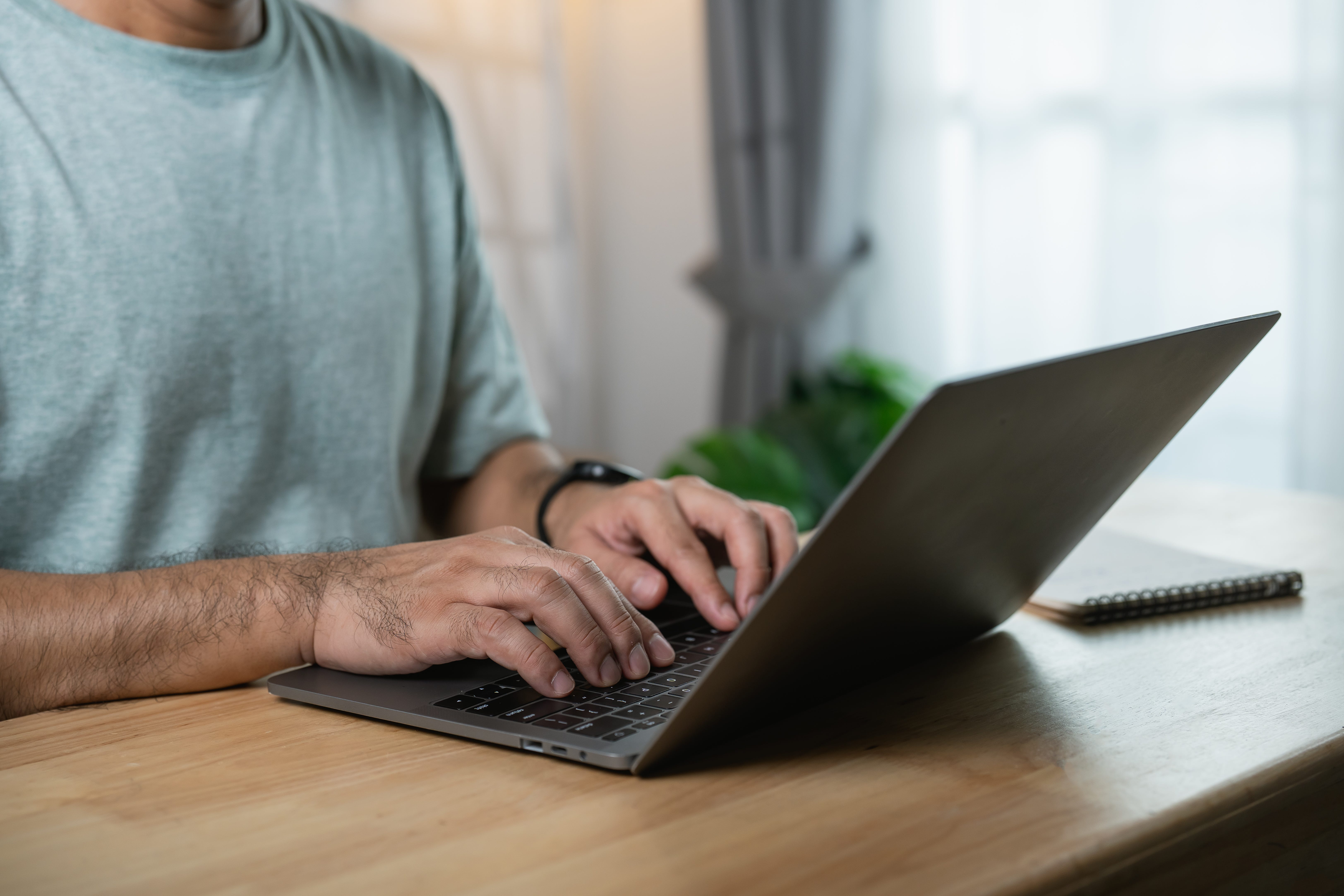 Man typing on a laptop.