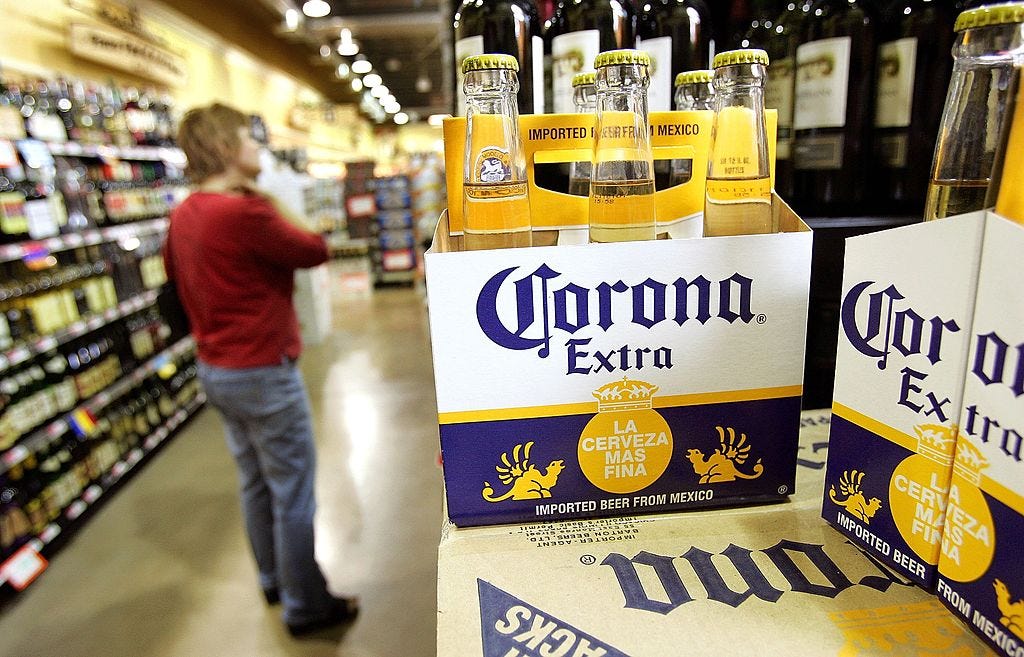 A woman shops for wine in the wine aisle near a six-pack of Corona Extra beer in a grocery store May 9, 2006 in Des Plaines, Illinois.
