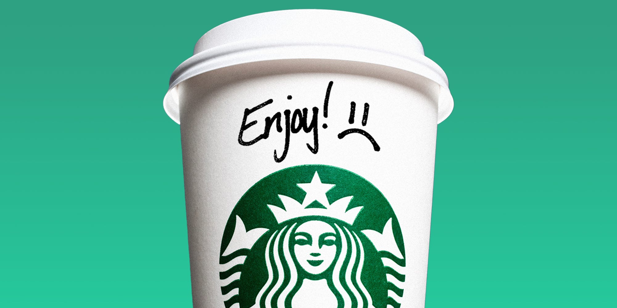 Starbucks cup with handwritten "Enjoy!" message followed by frowny face