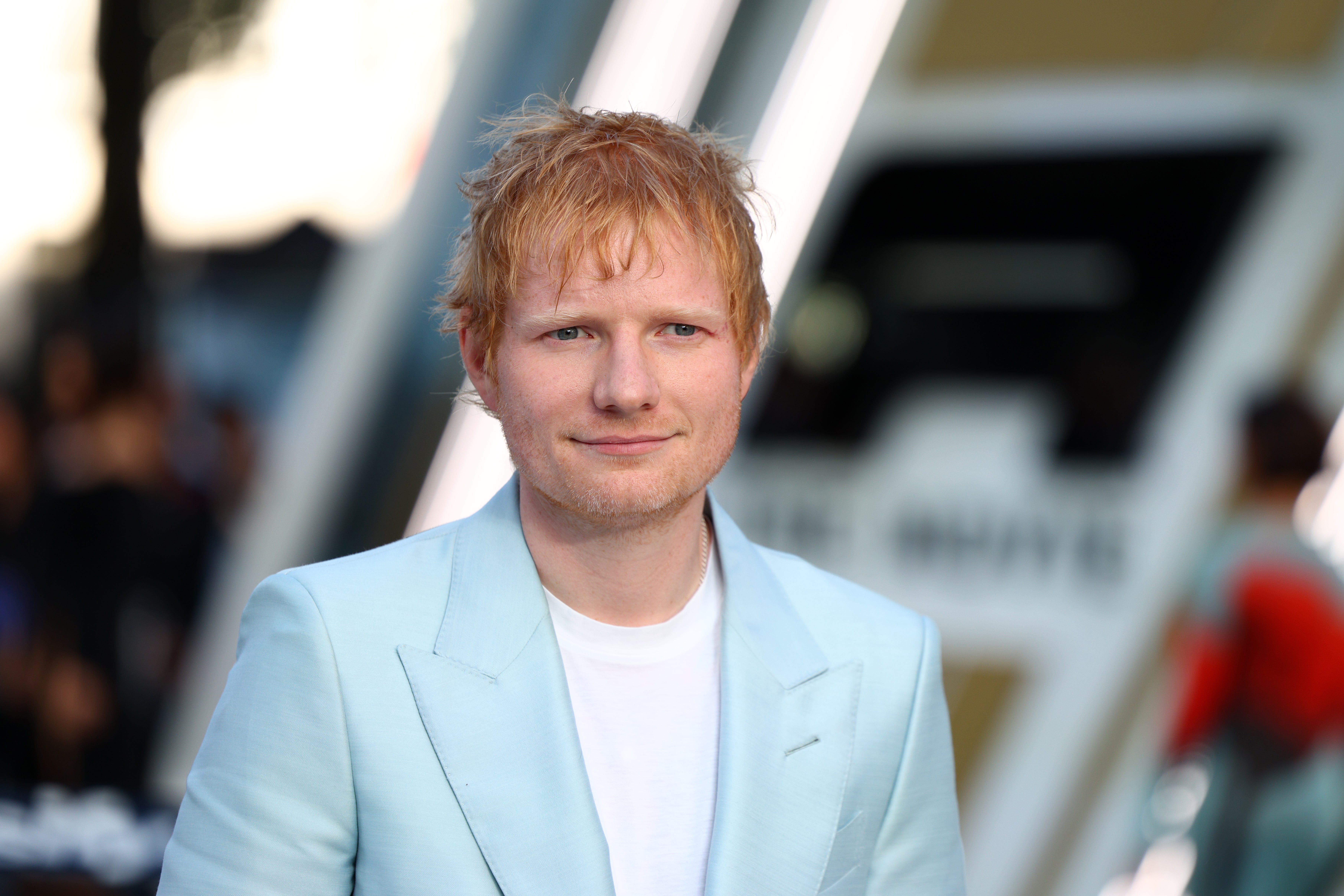 Ed Sheeran in a light blue suit.