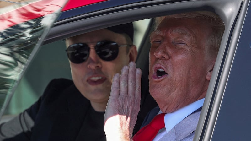 FILE PHOTO: U.S. President Donald Trump and Tesla CEO Elon Musk sit in a Tesla car model S, in front of the White House in Washington, D.C., U.S., March 11, 2025. REUTERS/Kevin Lamarque/File Photo