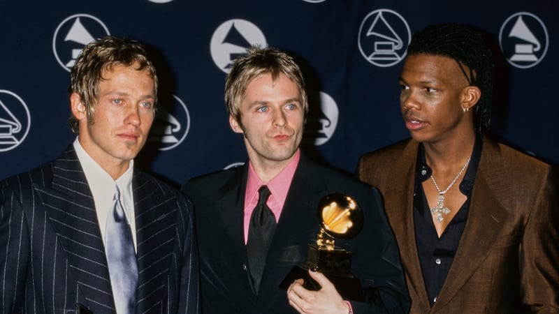 American Christian rap and rock band DC Talk (American singer, songwriter and poet Kevin Max Smith, American singer, songwriter and rapper TobyMac (Toby McKeehan), and American singer and songwriter Michael Tait) in the press room of the 39th Annual Grammy Awards, held at Madison Square Garden in Midtown Manhattan, New York City, New York, 26th February 1997. The trio won the Best Rock Gospel Album award for their album 'Jesus Freak'.