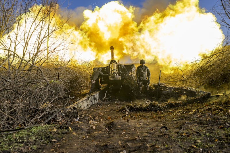 A Ukrainian soldier of an artillery unit fires towards Russian positions outside Bakhmut on November 8, 2022.