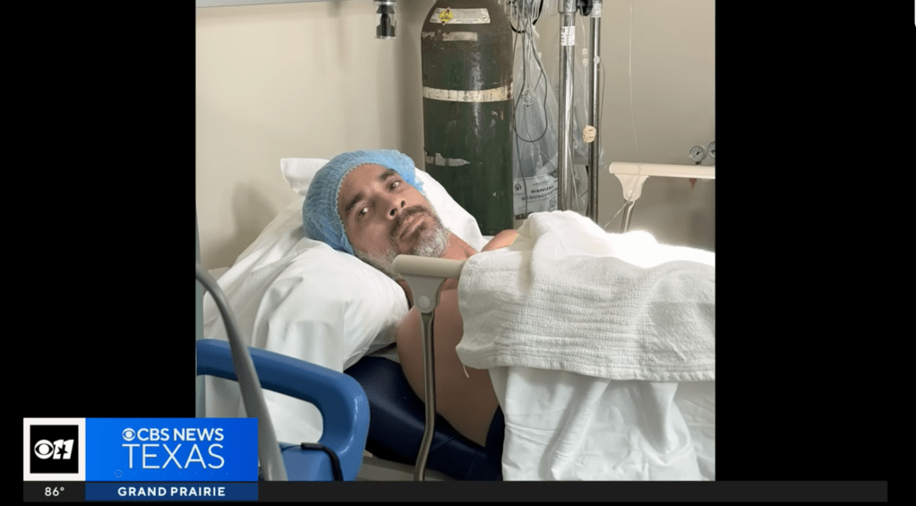 Brent Slough in a hospital bed after being struck by a boat while snorkeling with his family in the Bahamas on June 30, 2025. 