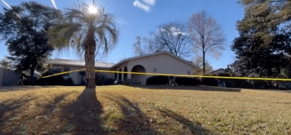House with yellow crime scene tape.