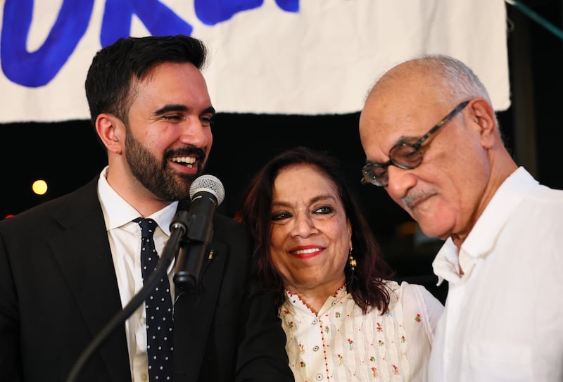 Zohran Mamdani stands with his mother Mira Nair and father Mahmood Mamdani as they celebrate during an election night on June 24.
