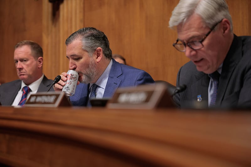 WASHINGTON, DC - JUNE 03: Senate Judiciary Committee member Sen. Ted Cruz (R-TX) (C) sips soda during a subcommittee hearing about the unprecedented number of nationwide judicial injunctions against the Trump Administration with Sen. Eric Schmidt (R-MO) (L) and Sen. Sheldon Whitehouse (D-RI) in the Dirksen Senate Office Building on Capitol Hill on June 03, 2025 in Washington, DC. The hearing, titled