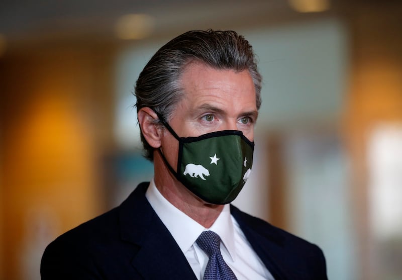 OAKLAND, CALIFORNIA - DECEMBER 22: Gov. Gavin Newsom listens during a press conference at the Native American Health Center in Oakland, Calif., on Wednesday, Dec. 22, 2021. (Jane Tyska/Digital First Media/East Bay Times via Getty Images)