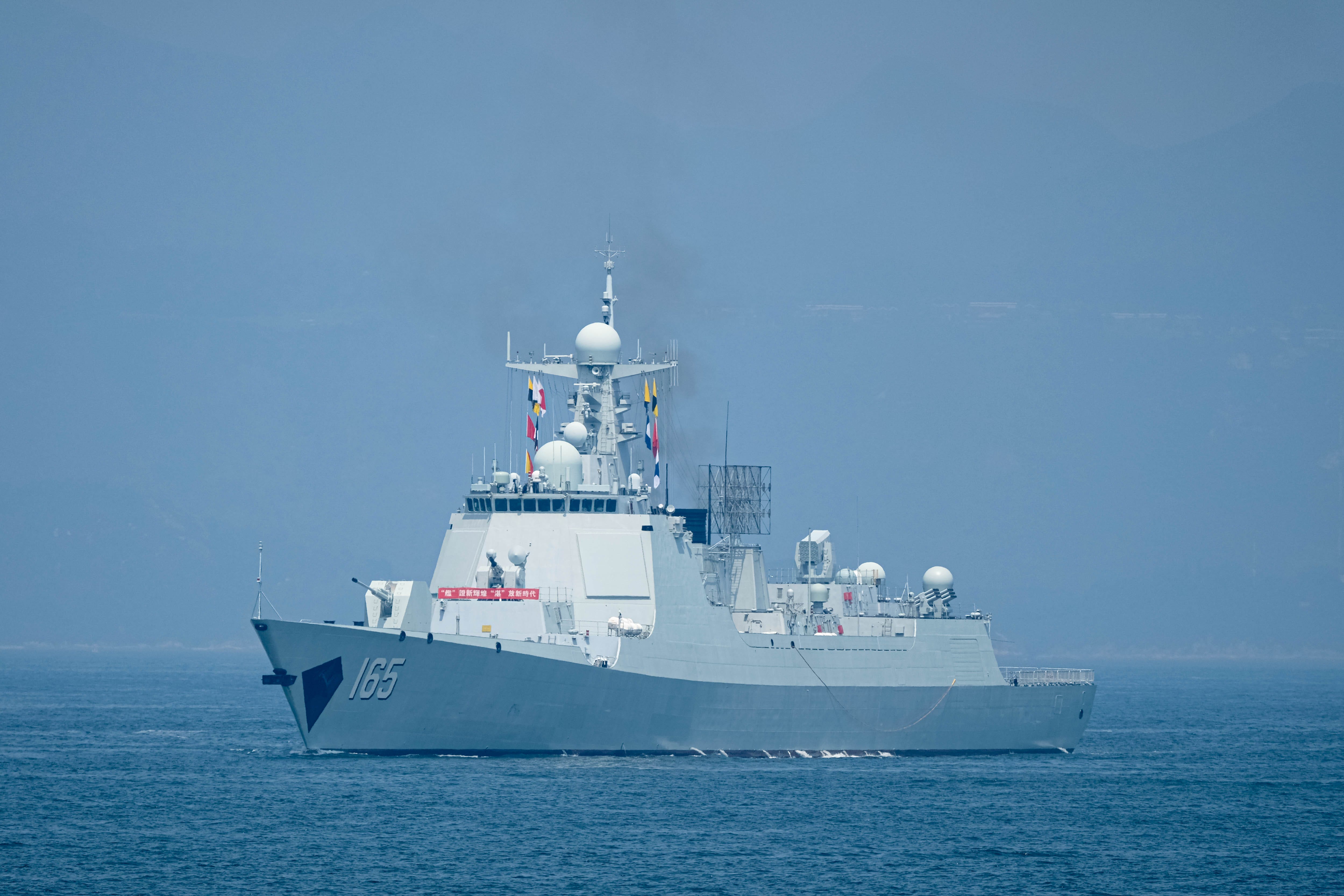The Chinese People's Liberation Army Navy missile destroyer Zhanjiang sails through Victoria Harbour. Led by the aircraft carrier Shandong, the fleet departed on Monday morning, concluding a five-day visit to Hong Kong.