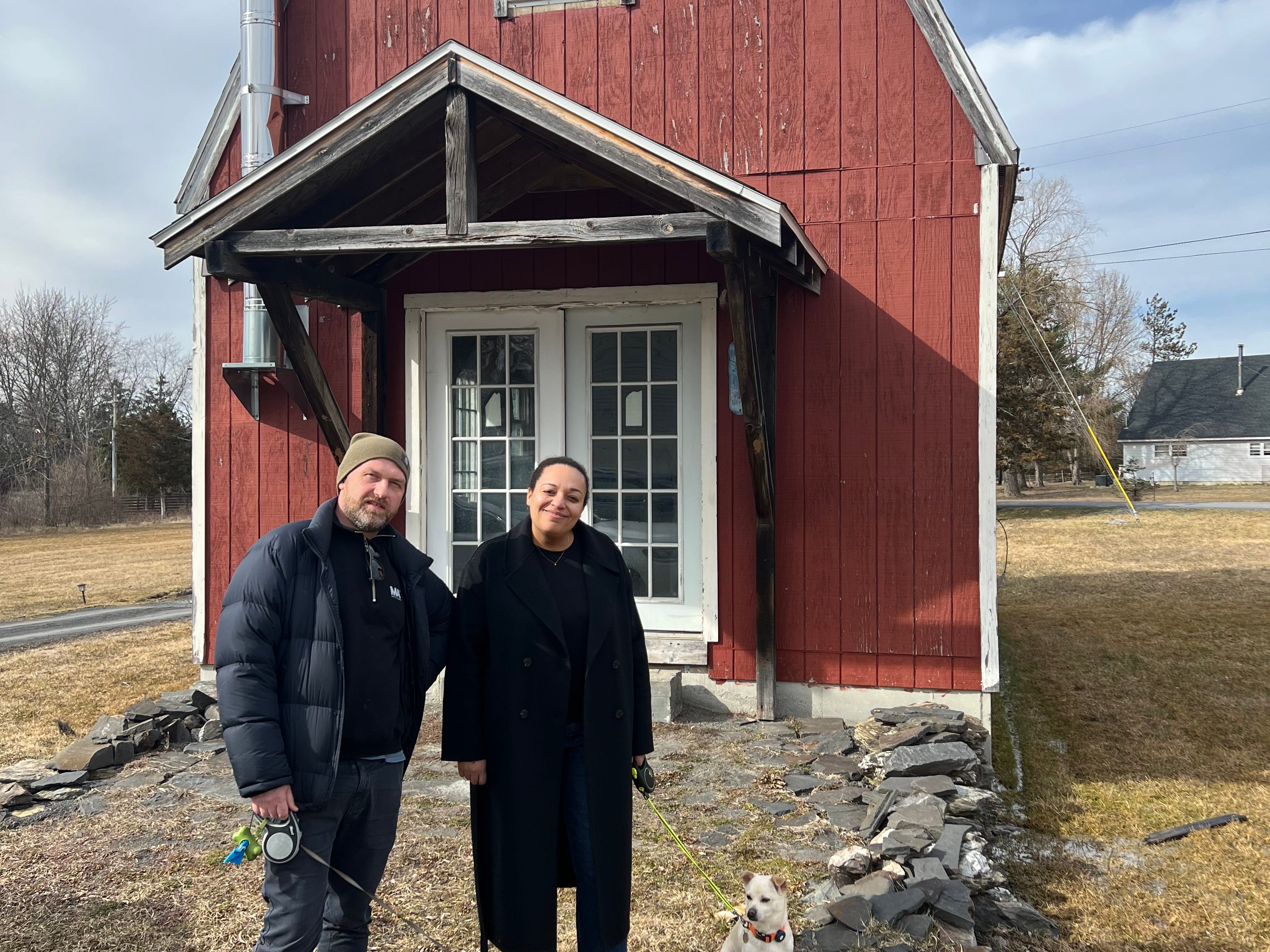 Wade and Selena Lounds standing in front of their barn.