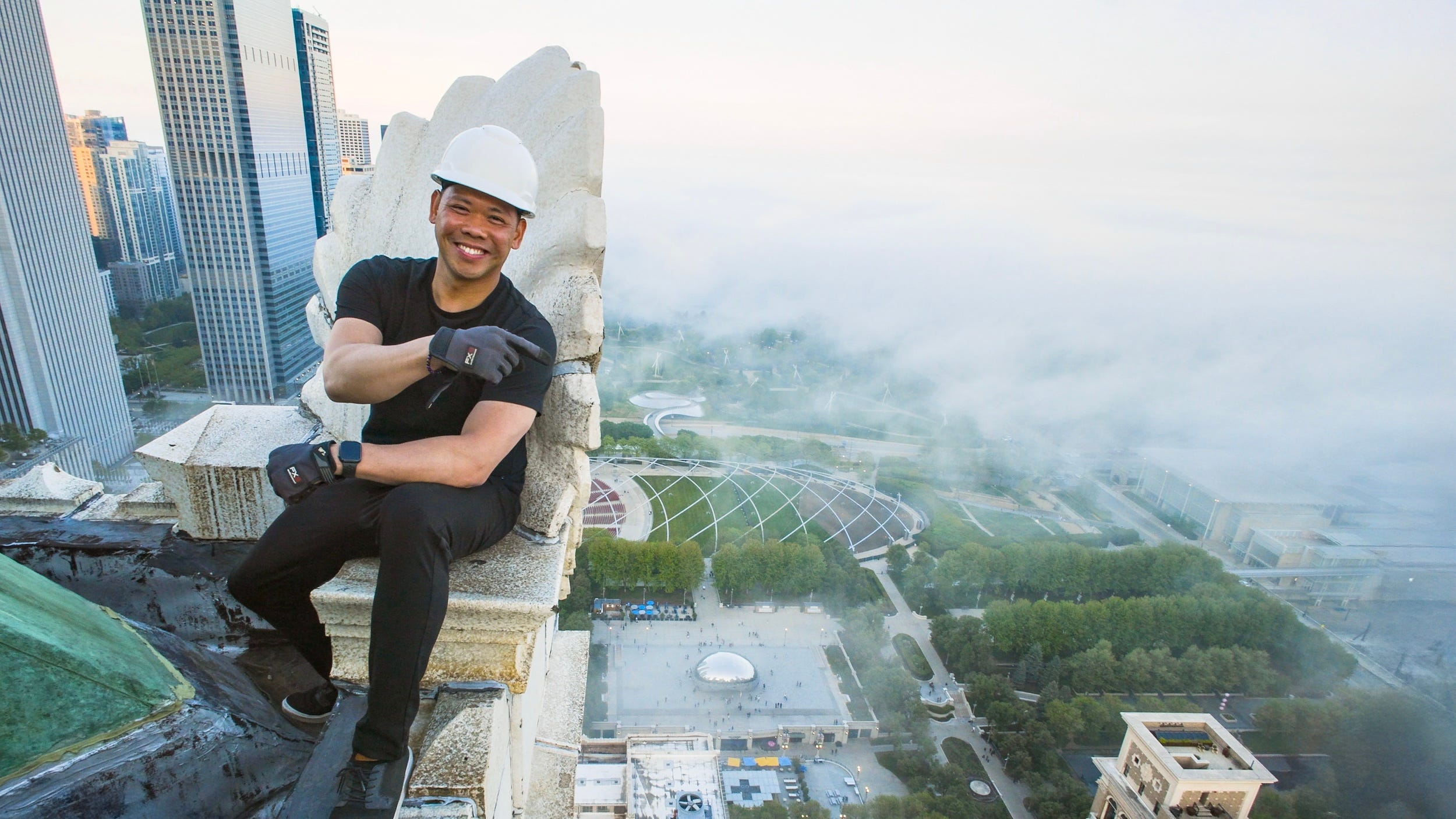 A man on top of a skyscraper in Chicago.