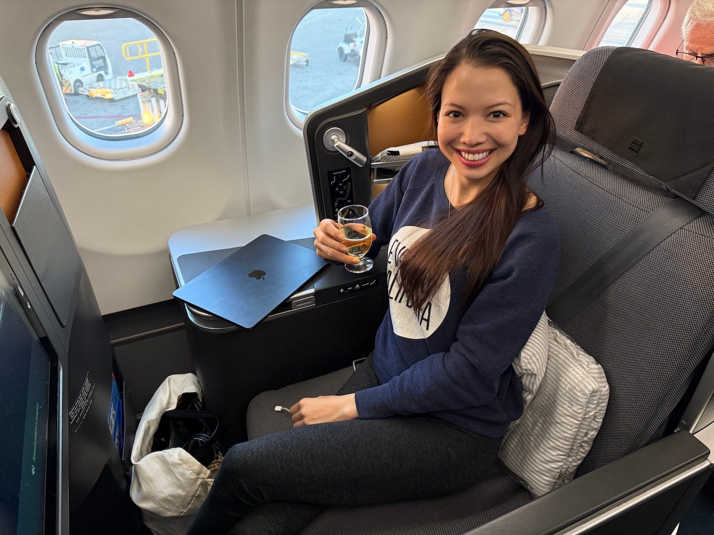 Author Amber Gibson smiling in business class seat on SAS plane