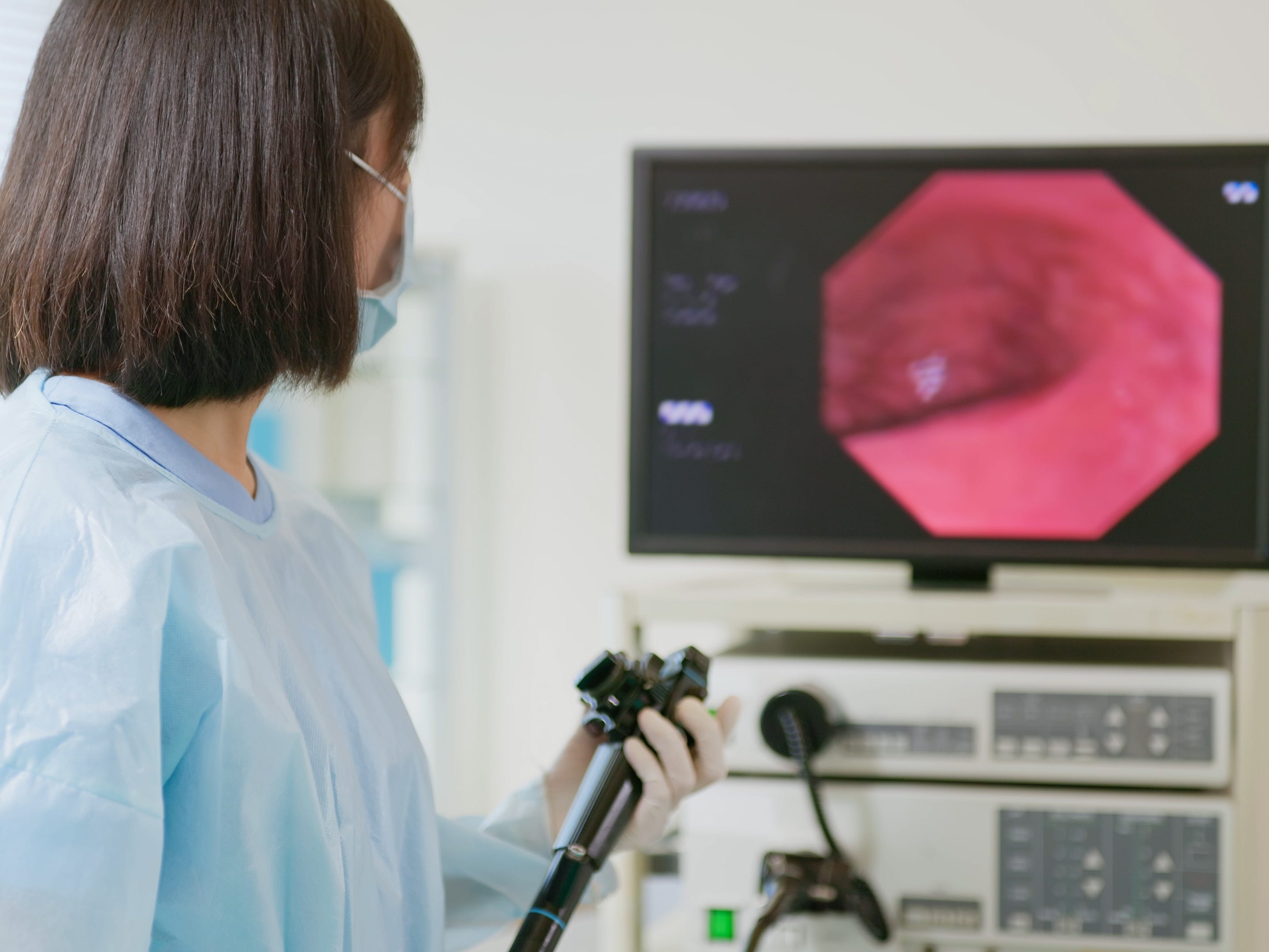 A doctor performing a colonoscopy.