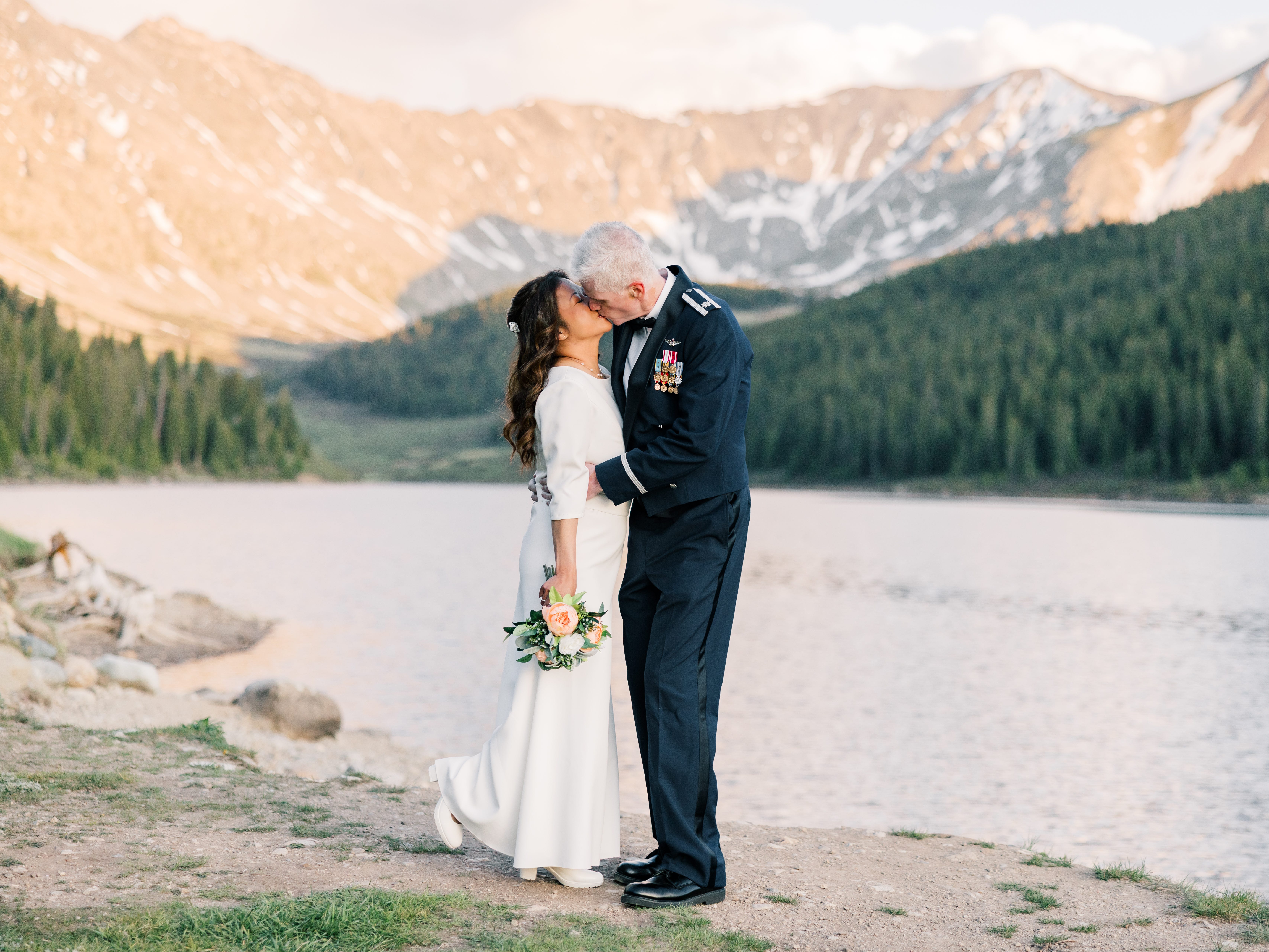 Kate Agathon and her husband kissing on their wedding day in her wedding dress