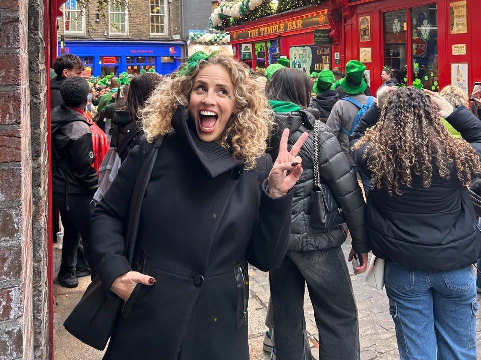 Author Alesandra Dubin smiling on busy street in Dubling
