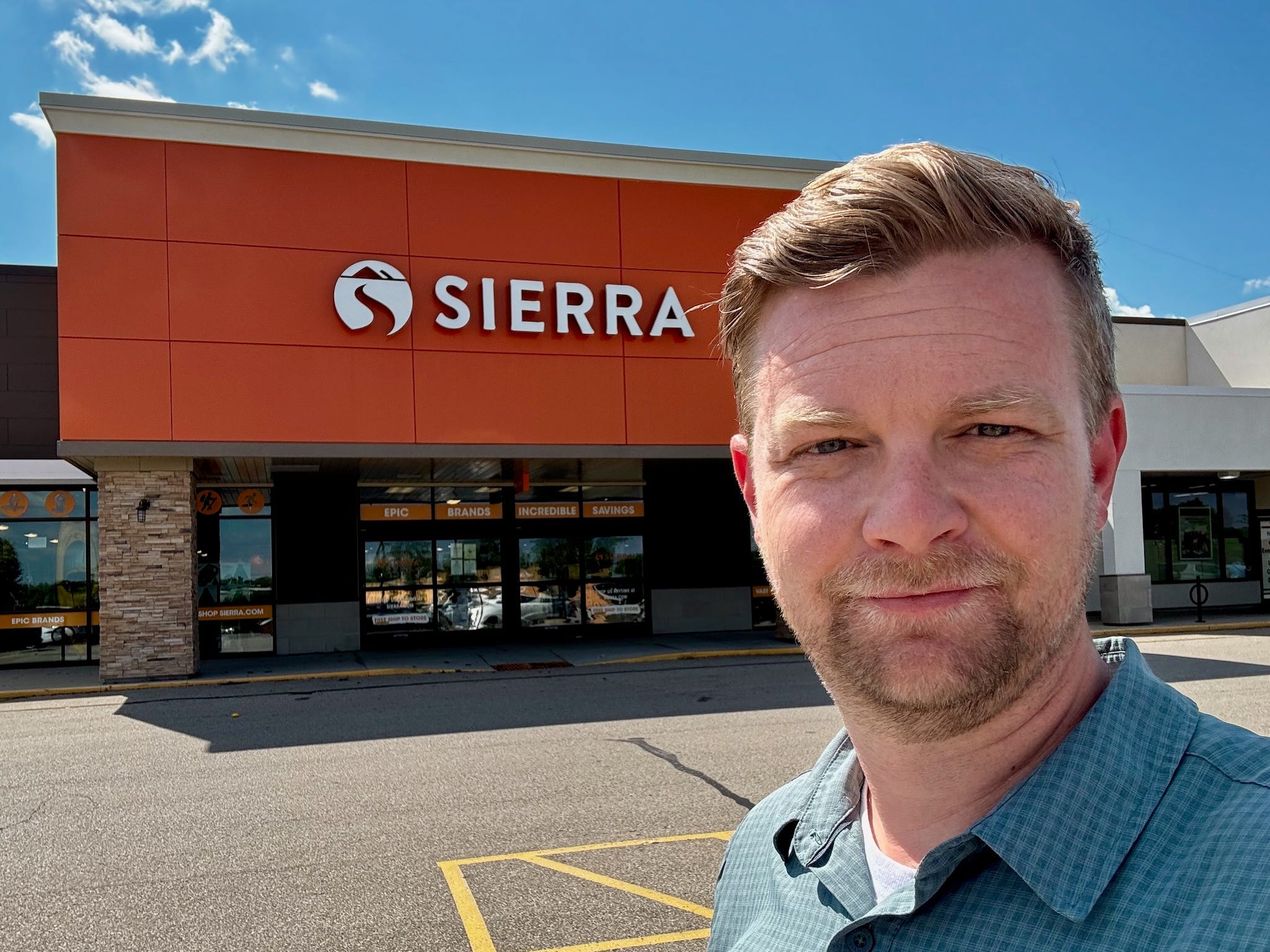 Dominick Reuter in front of a Sierra retail store.