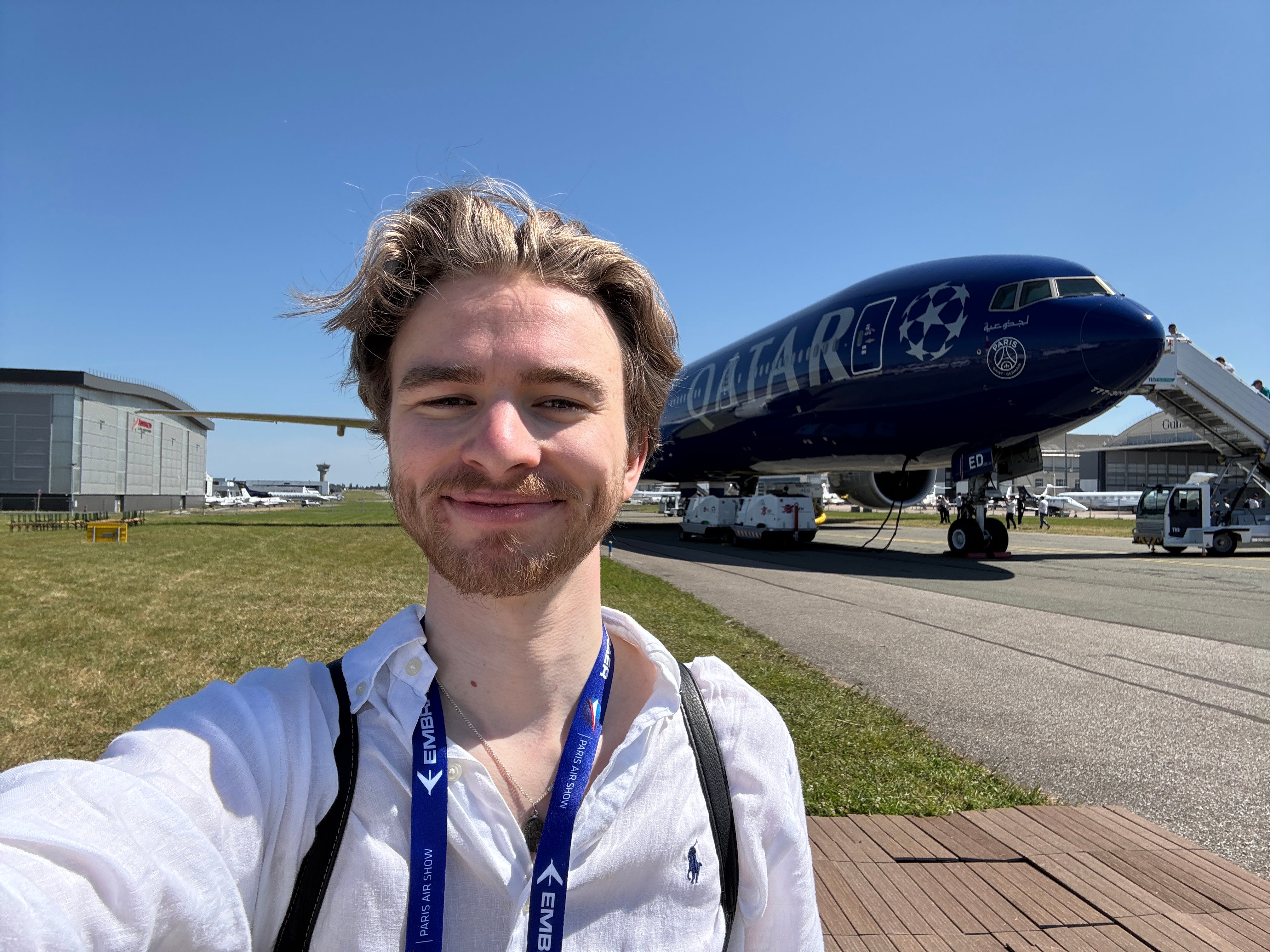The author takes a selfie in front of a Qatar Airways Boeing 777 in the PSG Champions League livery, at the 2025 Paris Air Show