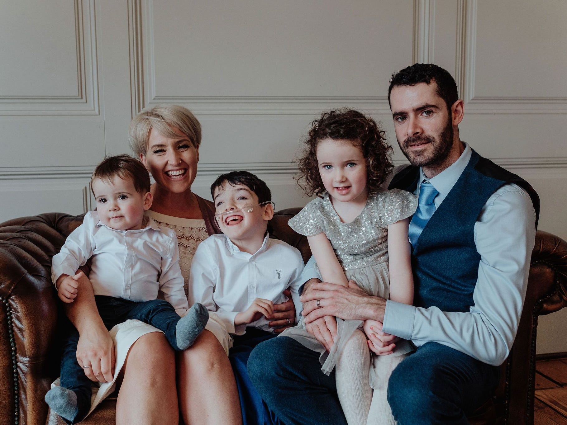 Sophie Condie with her husband and three kids, sitting on a sofa.