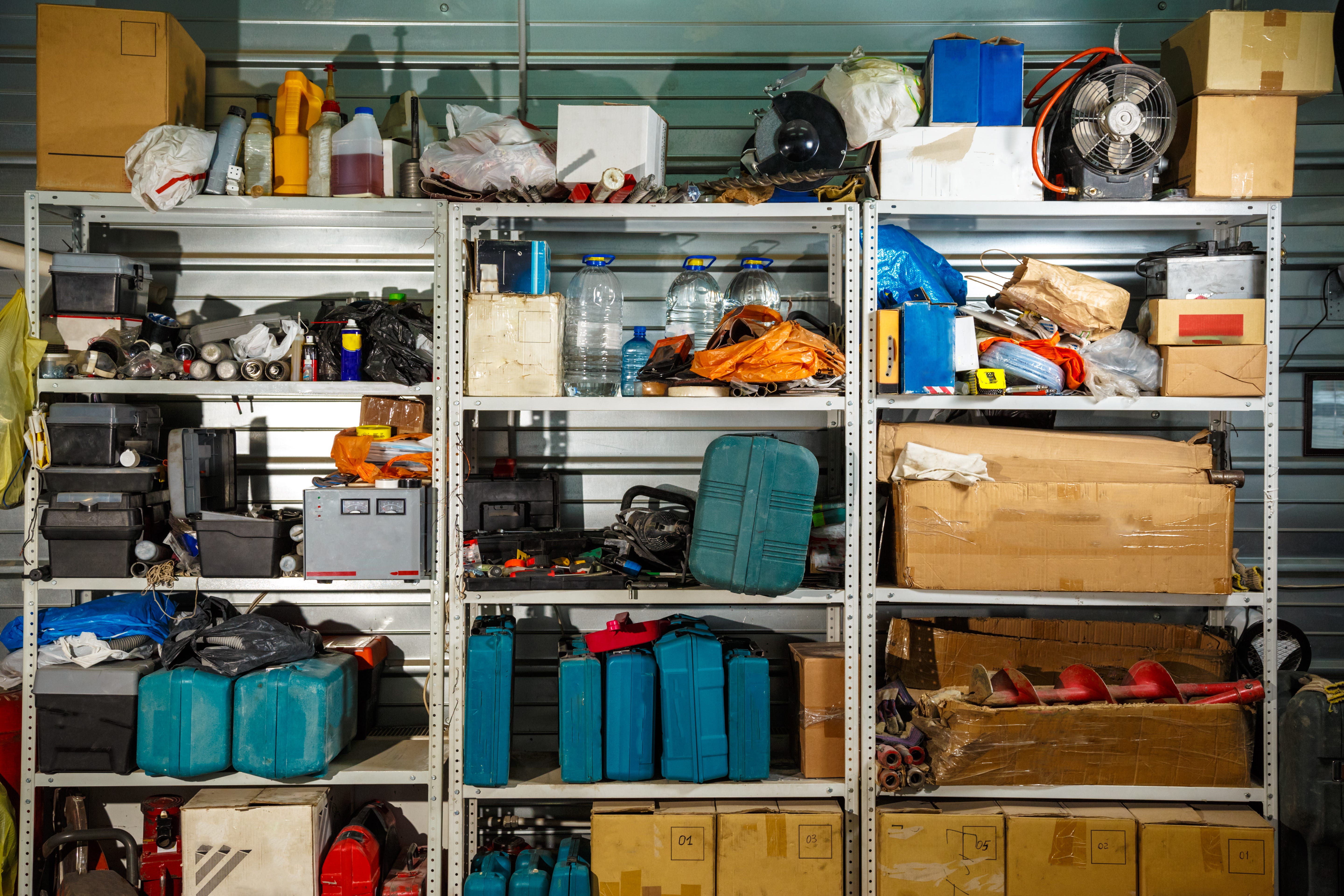 A stocked shelf in a garage.
