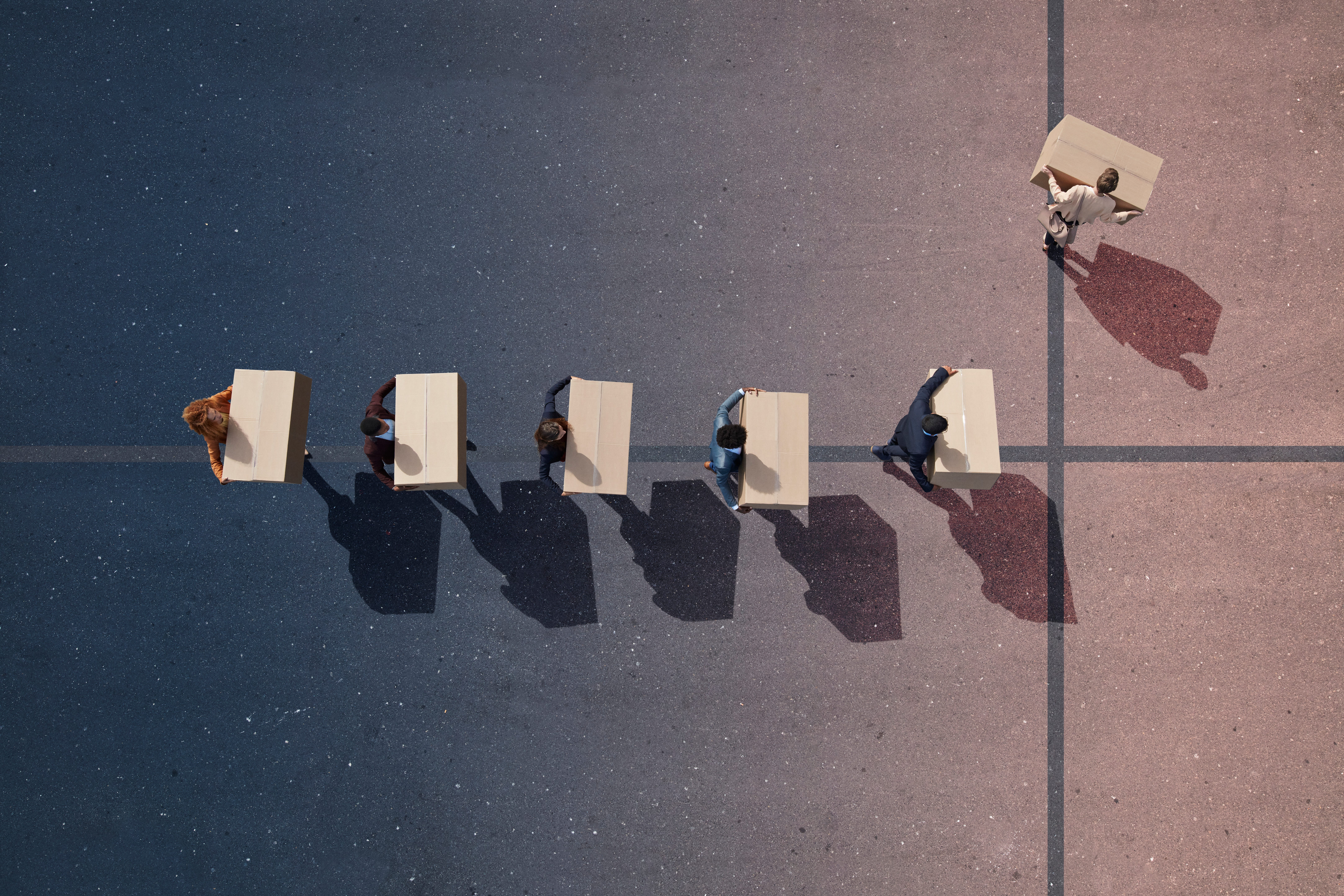 people lined up taking boxes