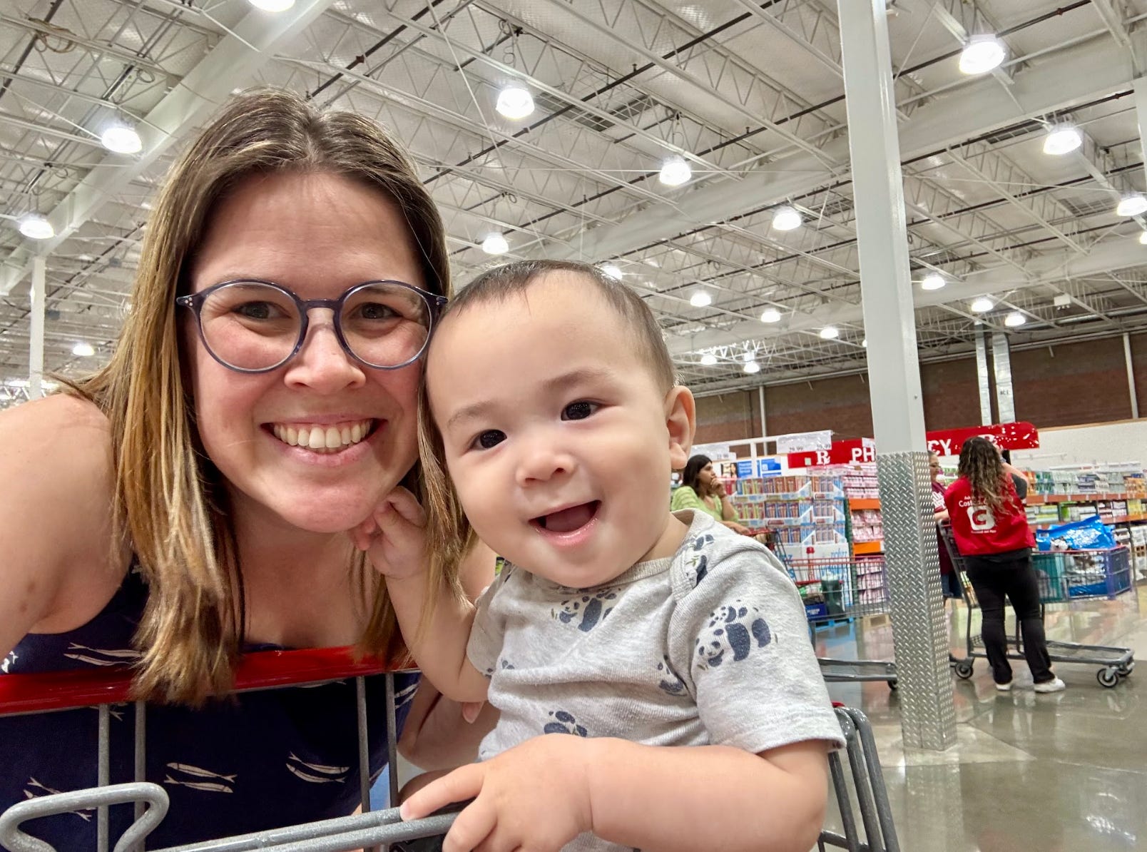 The writer and her baby grocery shopping at Costco.