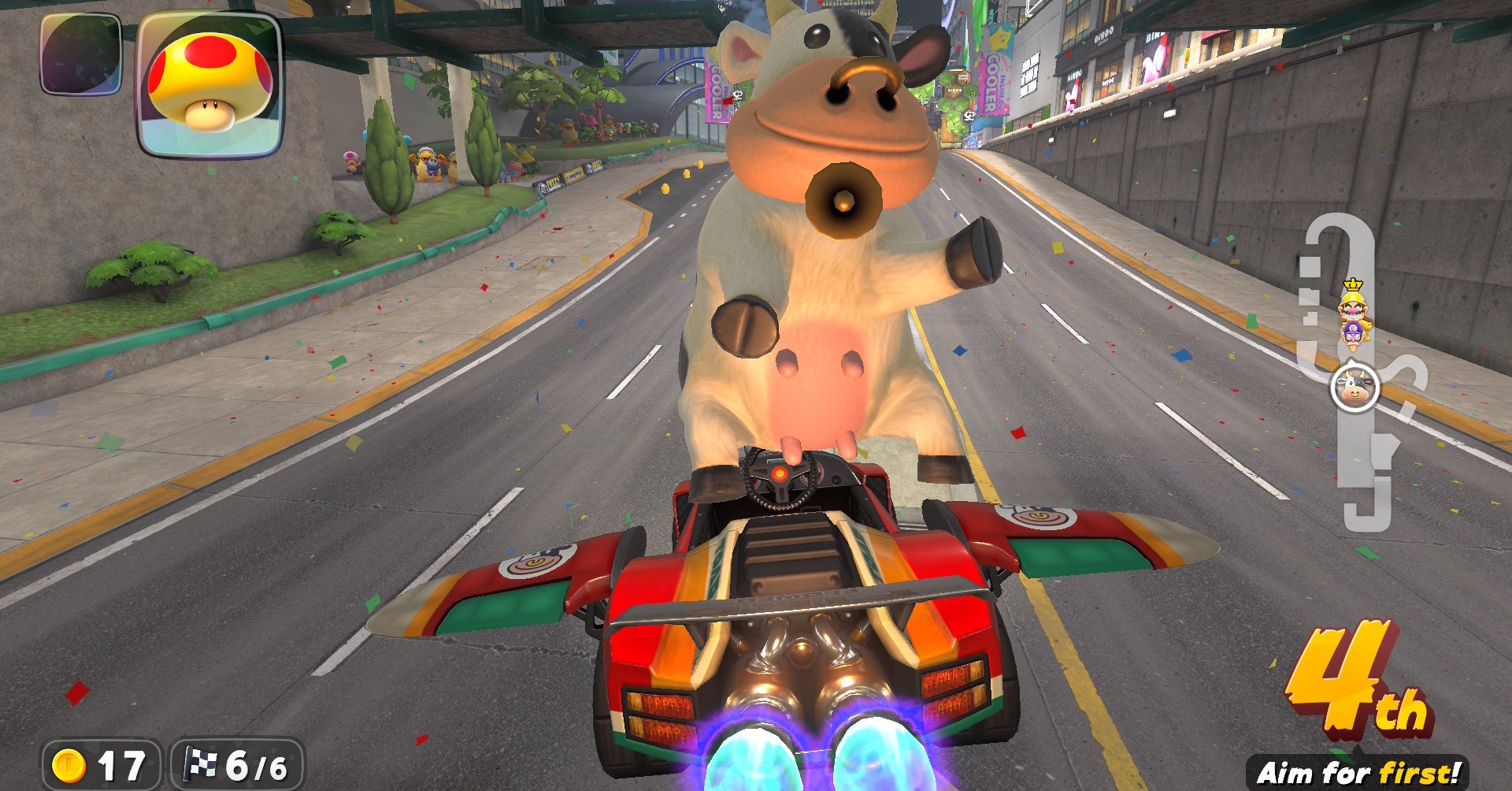The cow in Mario Kart World, posing on her hind legs while standing up in a car that’s flying like a plane