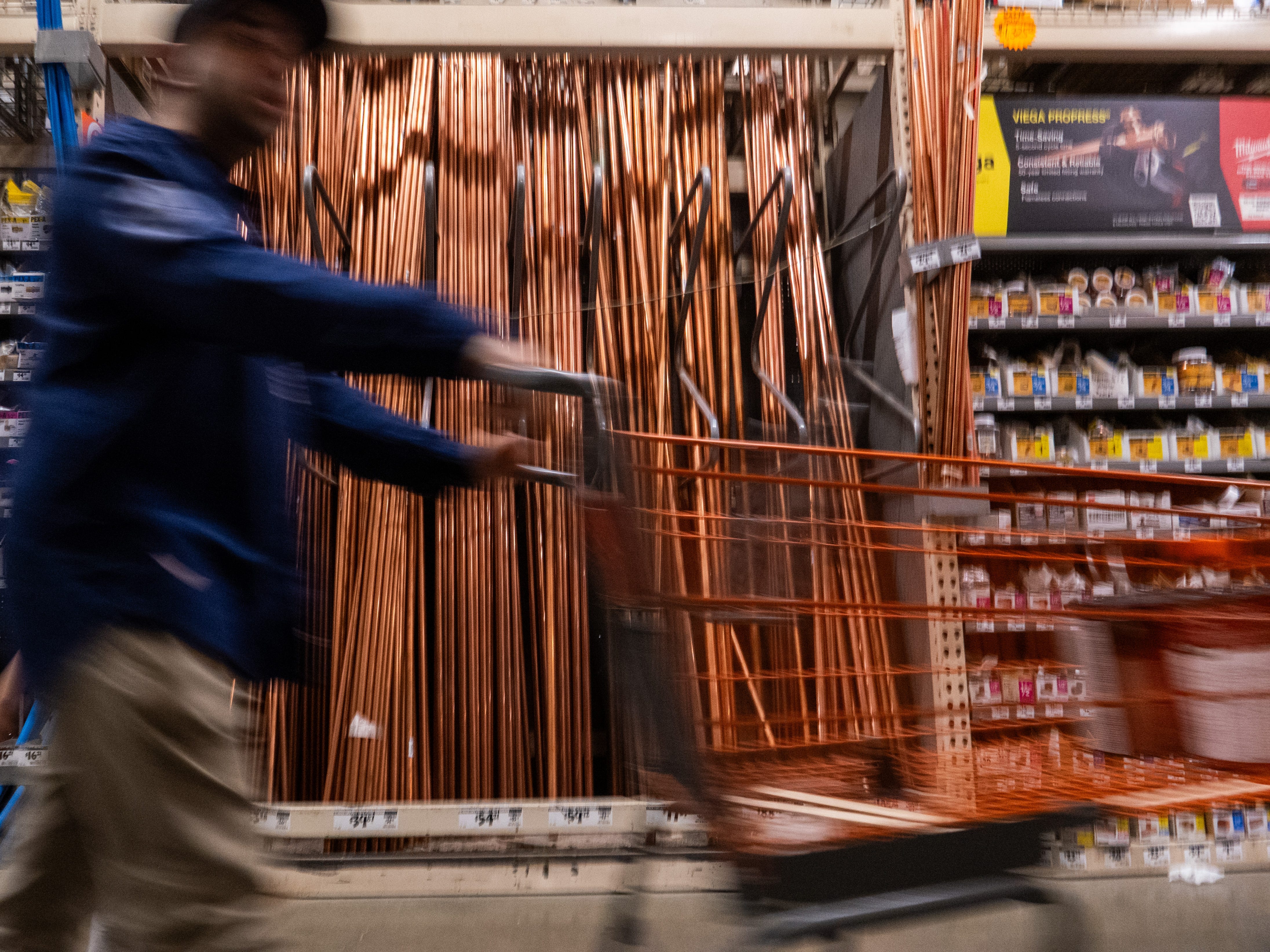 A person in a store with a cart