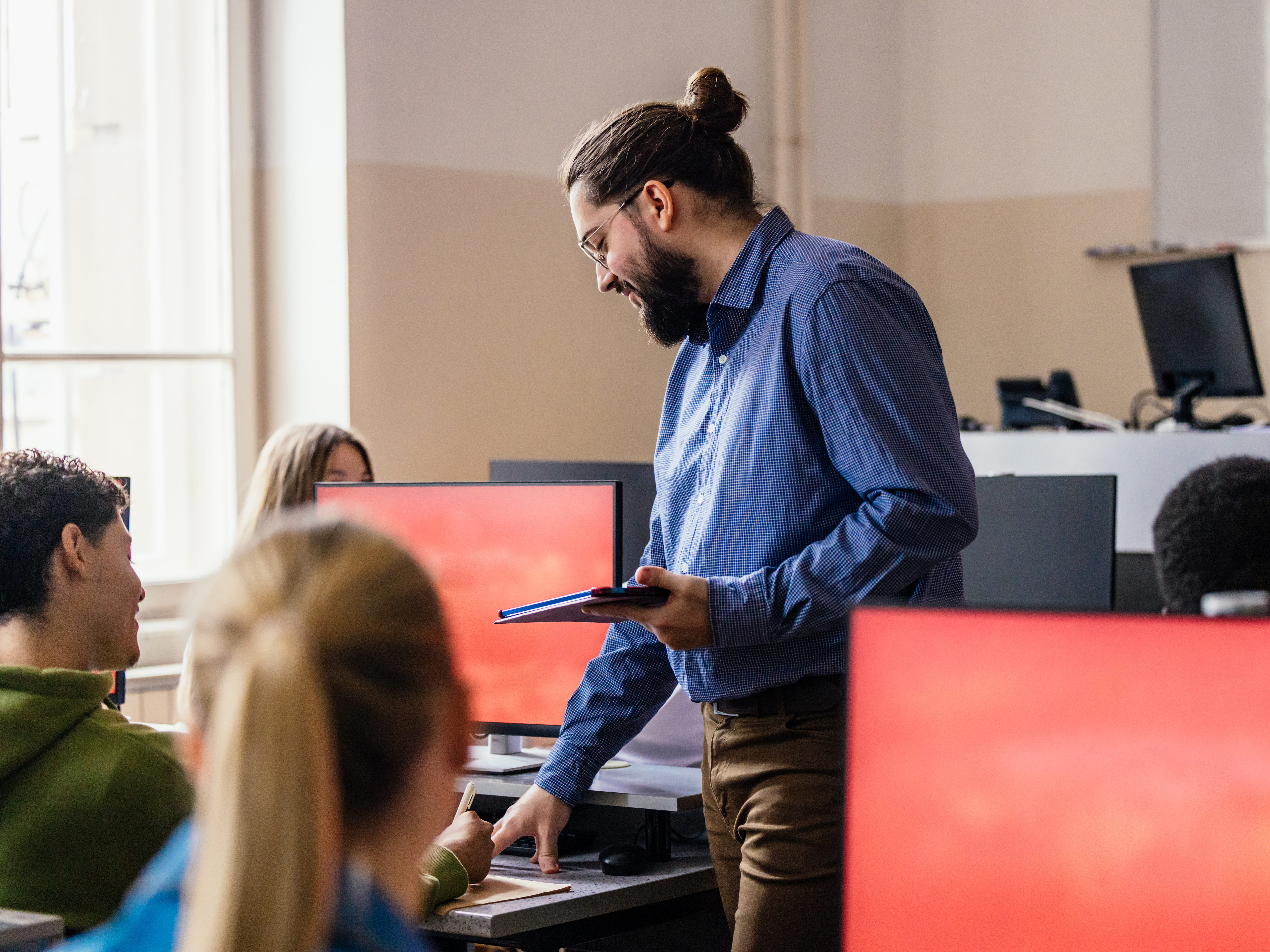a teacher walking through a computer lab