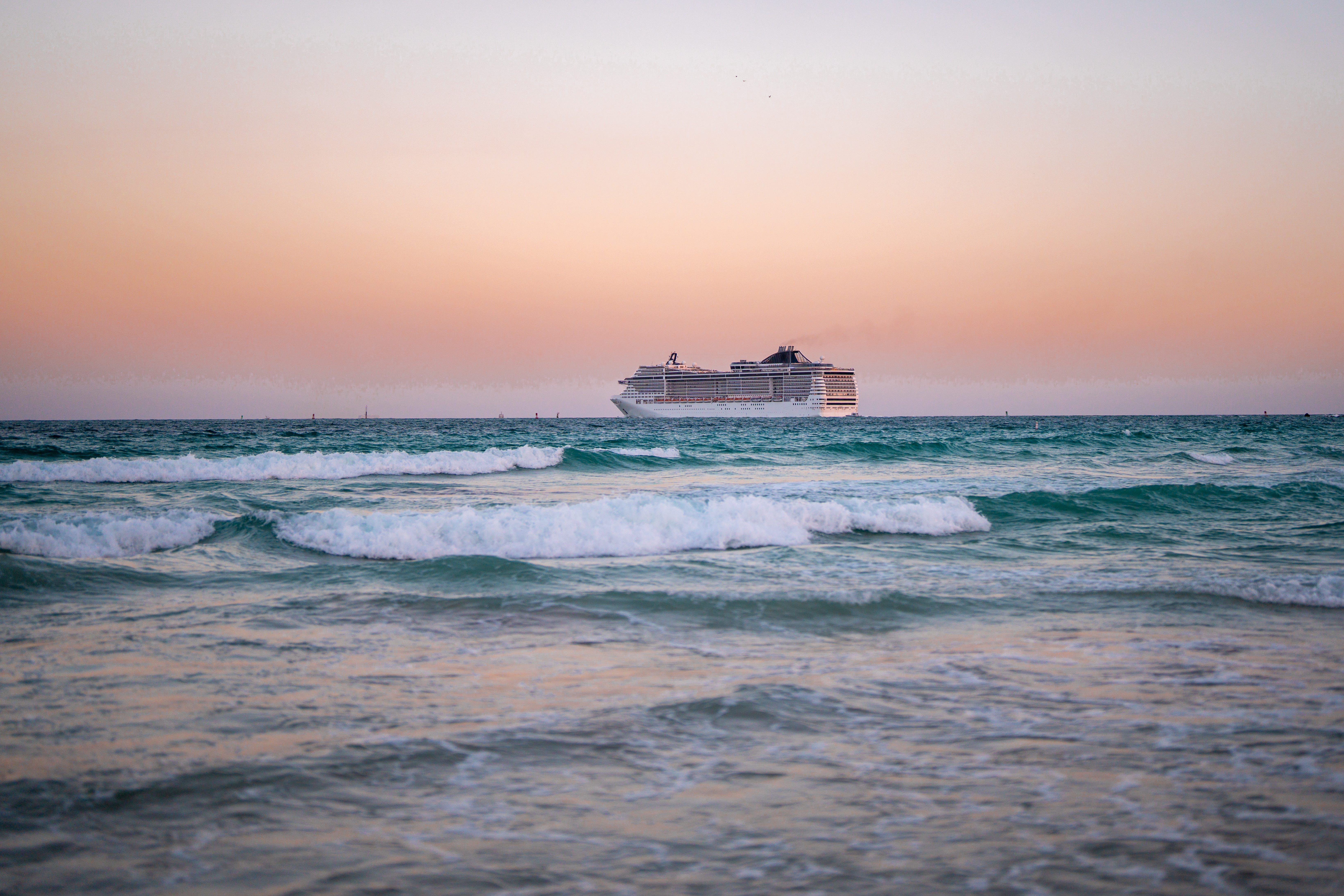A cruise ship in the water at sunrise