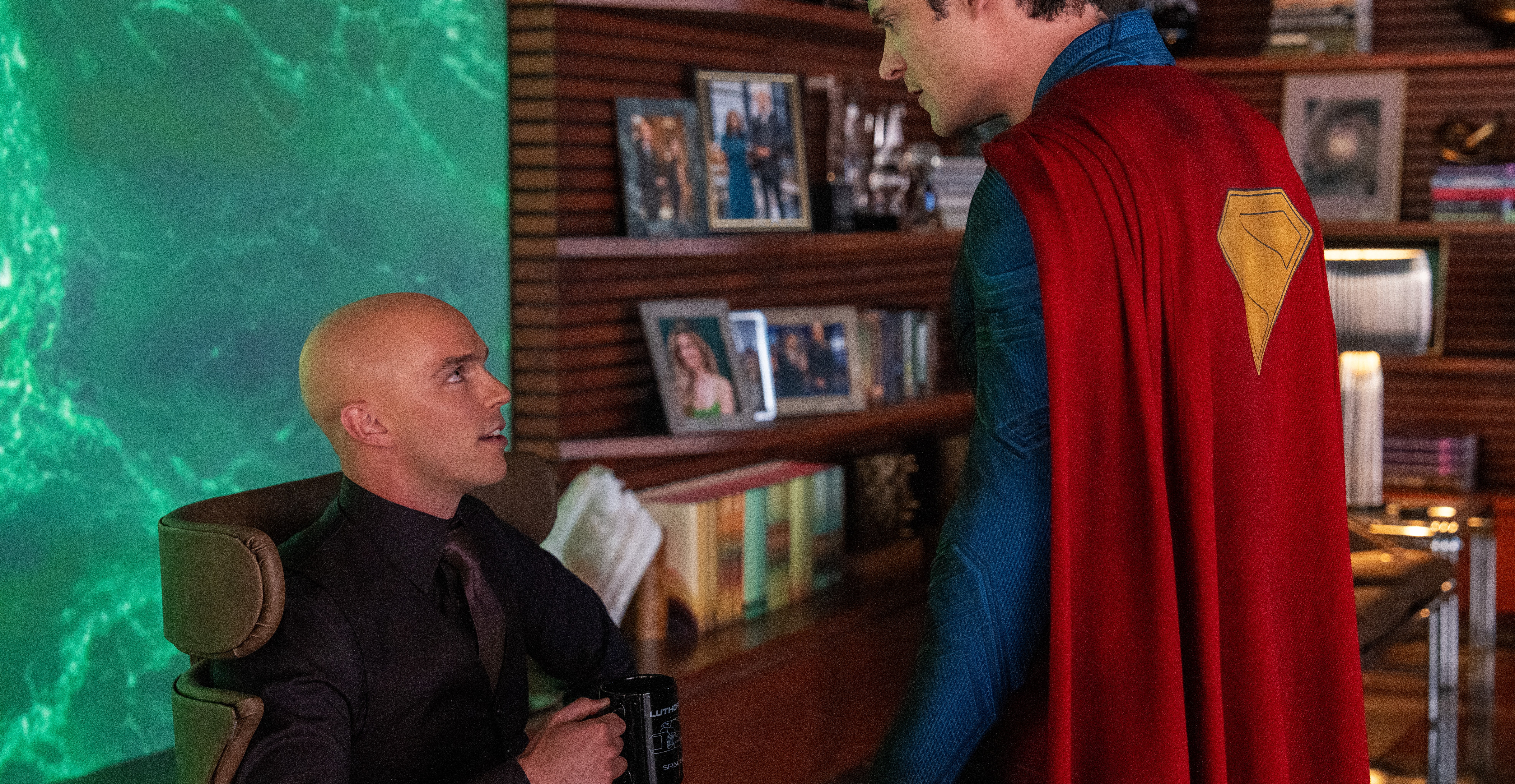 Superman glowers at Luthor, who smugly holds a coffee mug in James Gunn’s Superman