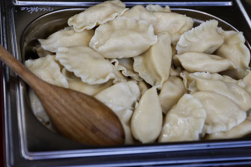 A tub of pierogi with a wooden spoon at the Easter market in Krakow, Poland on March 30, 2024.