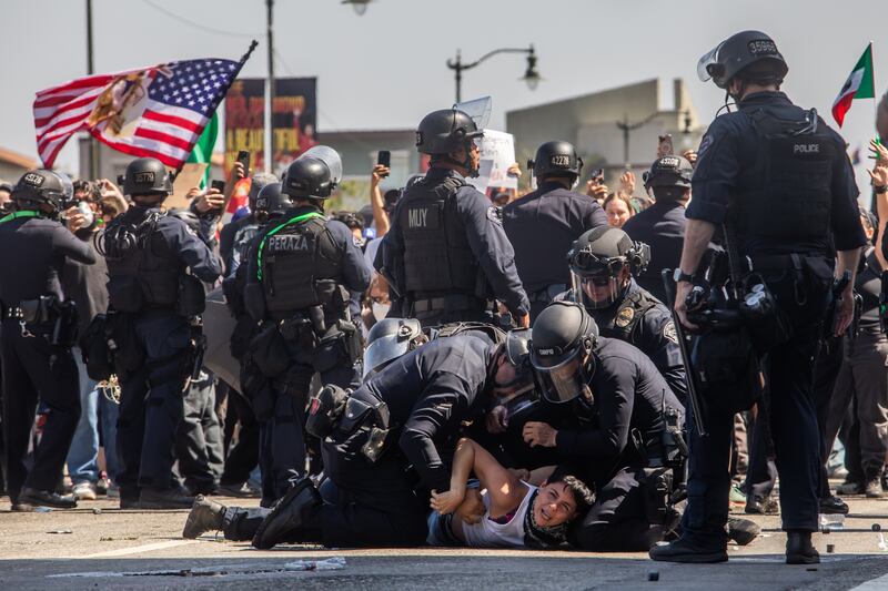 Los Angeles Police Department officers arrest a protester in front of the LA Federal Building on June 08, 2025 in Los Angeles, California.