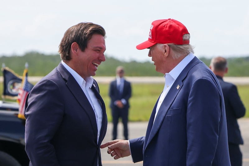 President Donald Trump met with Florida Gov. Ron DeSantis as soon as he deplaned from Air Force One at an airstrip adjacent to the so-called “Alligator Alcatraz” in the Everglades.