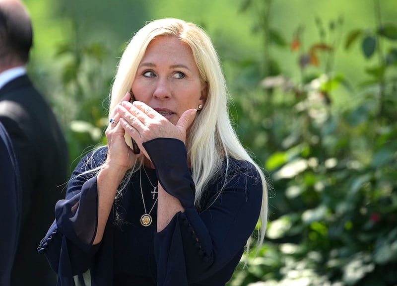 WASHINGTON, DC - MAY 01: U.S. Rep. Marjorie Taylor Greene (R-GA) talks on the phone during a National Day of Prayer event hosted by President Donald Trump in the Rose Garden at the White House on May 1, 2025 in Washington, DC The National Day of Prayer is a congressionally recognized observance that calls on people of all faiths to participate in a day of prayer and reflection. (Photo by Andrew Harnik/Getty Images)