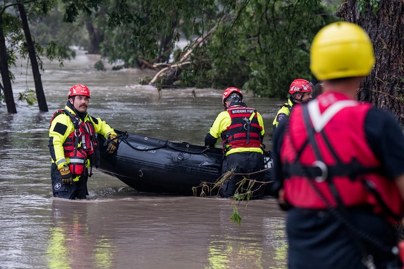 Boerne search and rescue team members prepare their Zodiac boat for operations on the flooded Guadalupe River on July 4, 2025 in Comfort, Texas.