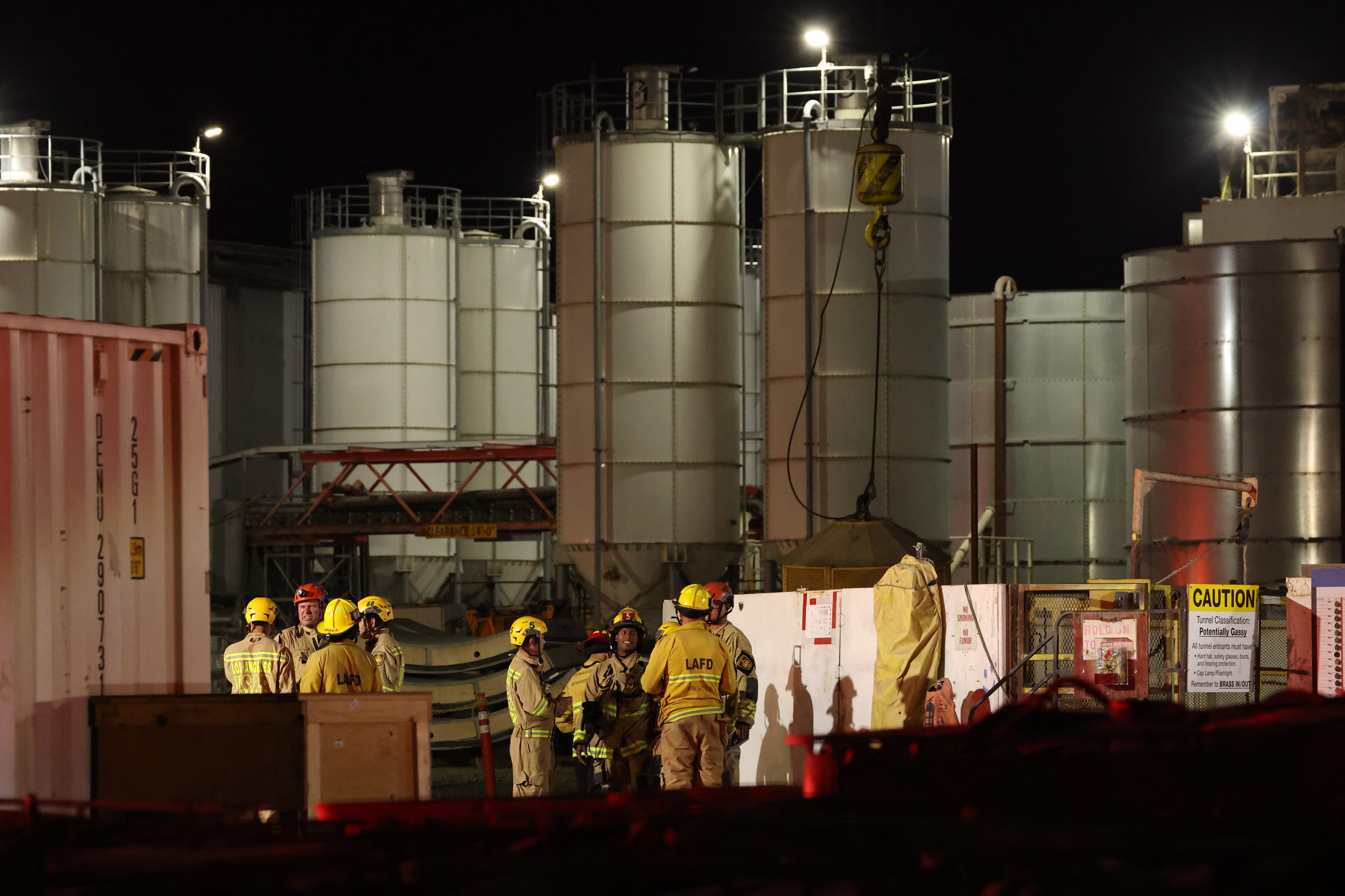Firefighters seen at the site of an industrial tunnel collapse in Wilmington.