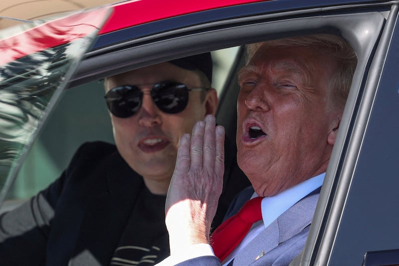 FILE PHOTO: U.S. President Donald Trump and Tesla CEO Elon Musk sit in a Tesla car model S, in front of the White House in Washington, D.C., U.S., March 11, 2025. REUTERS/Kevin Lamarque/File Photo