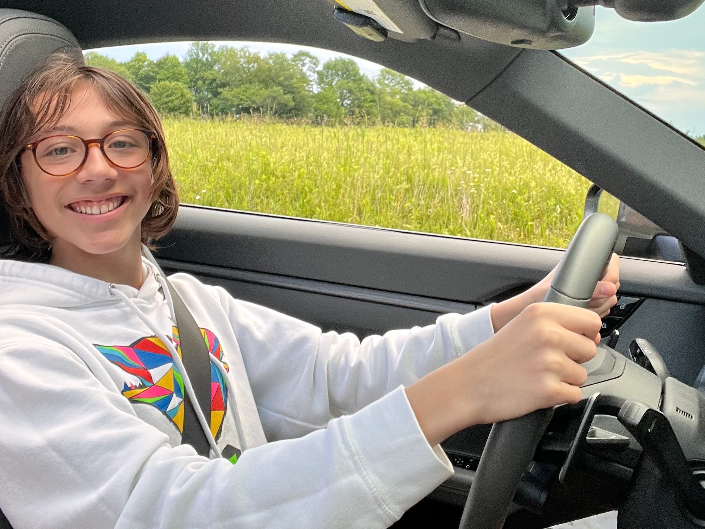 The author's son behind the wheel of a car.