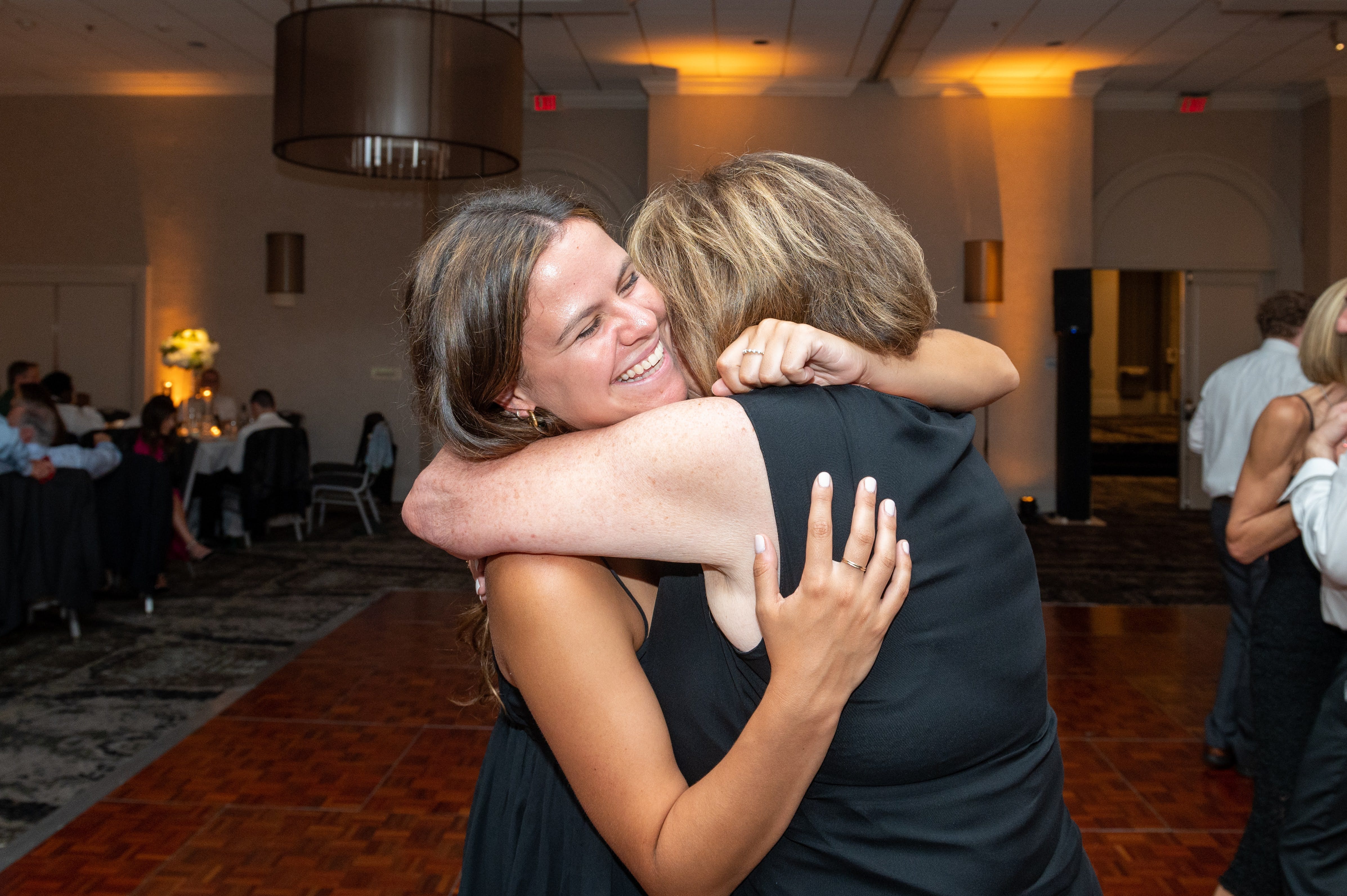 Author hugging her grandmother on the dancefloor at a wedding