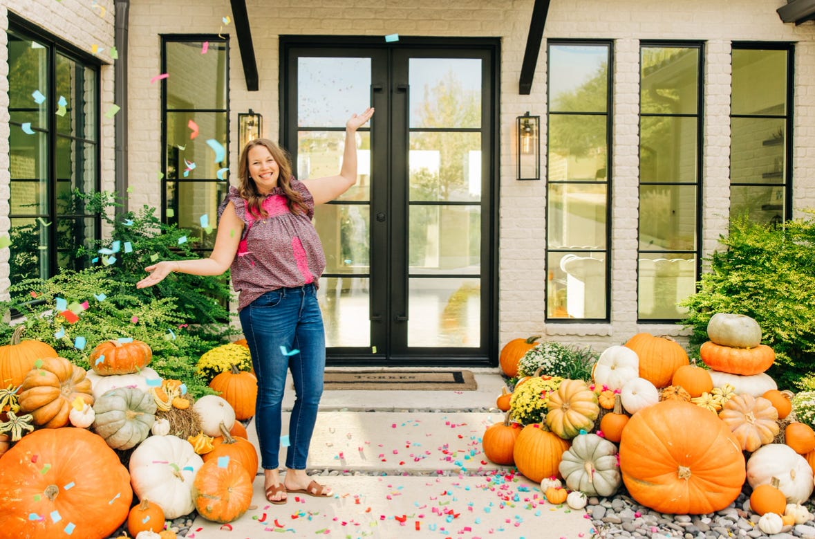 Heather Torres poses with a pumpkin display
