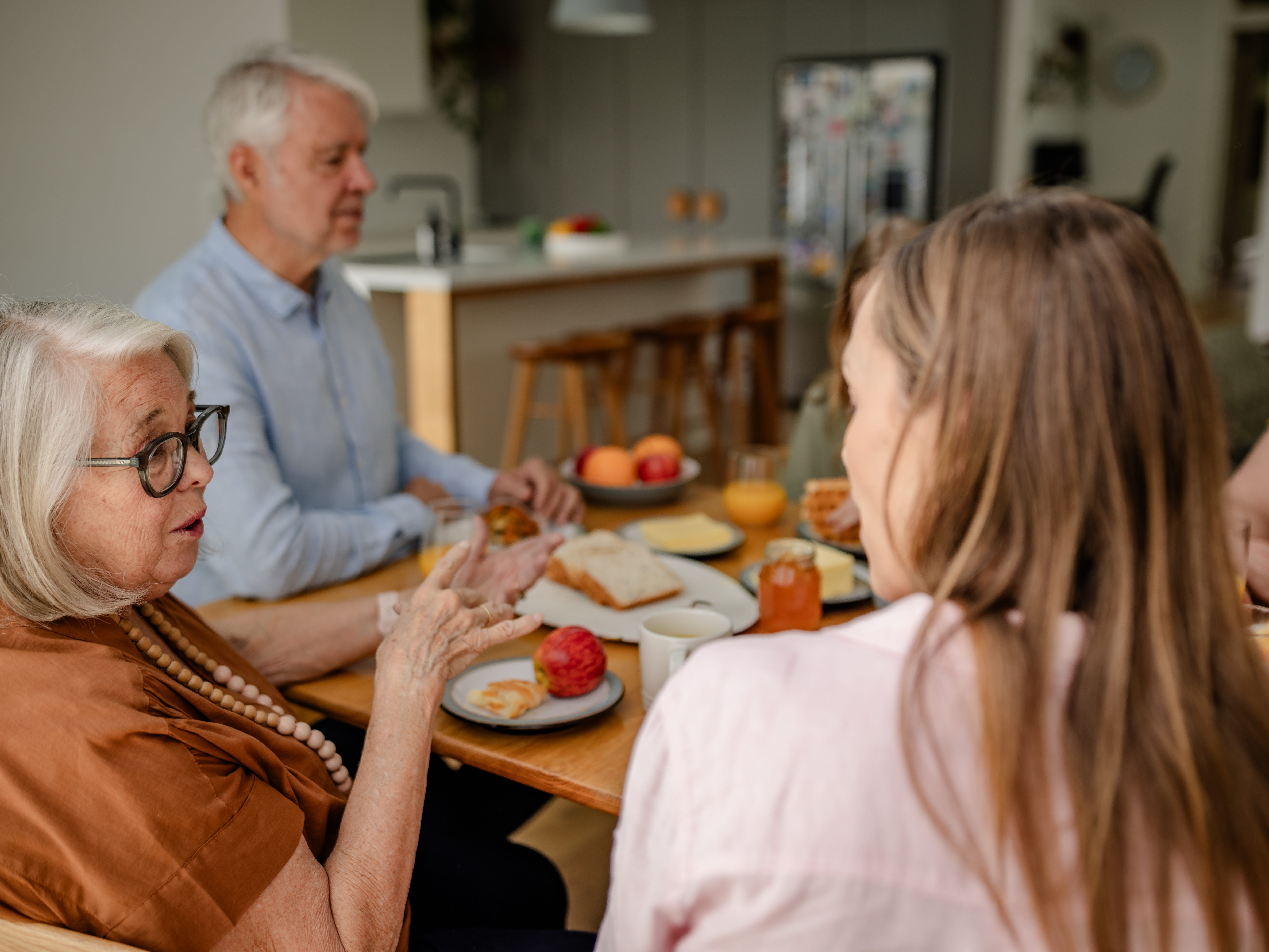 a family sitting at a dinner table