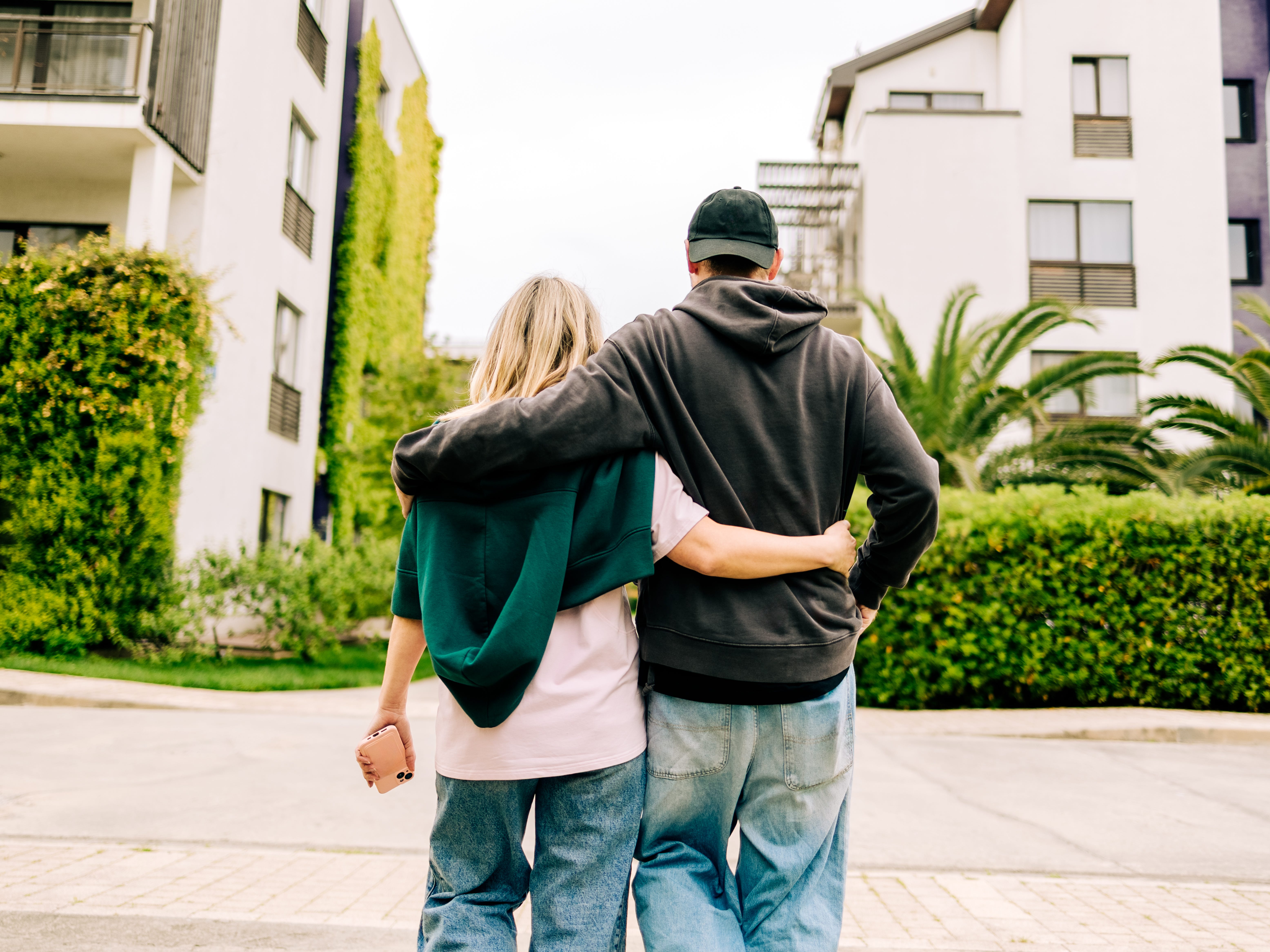A couple walking down the street arm in arm.