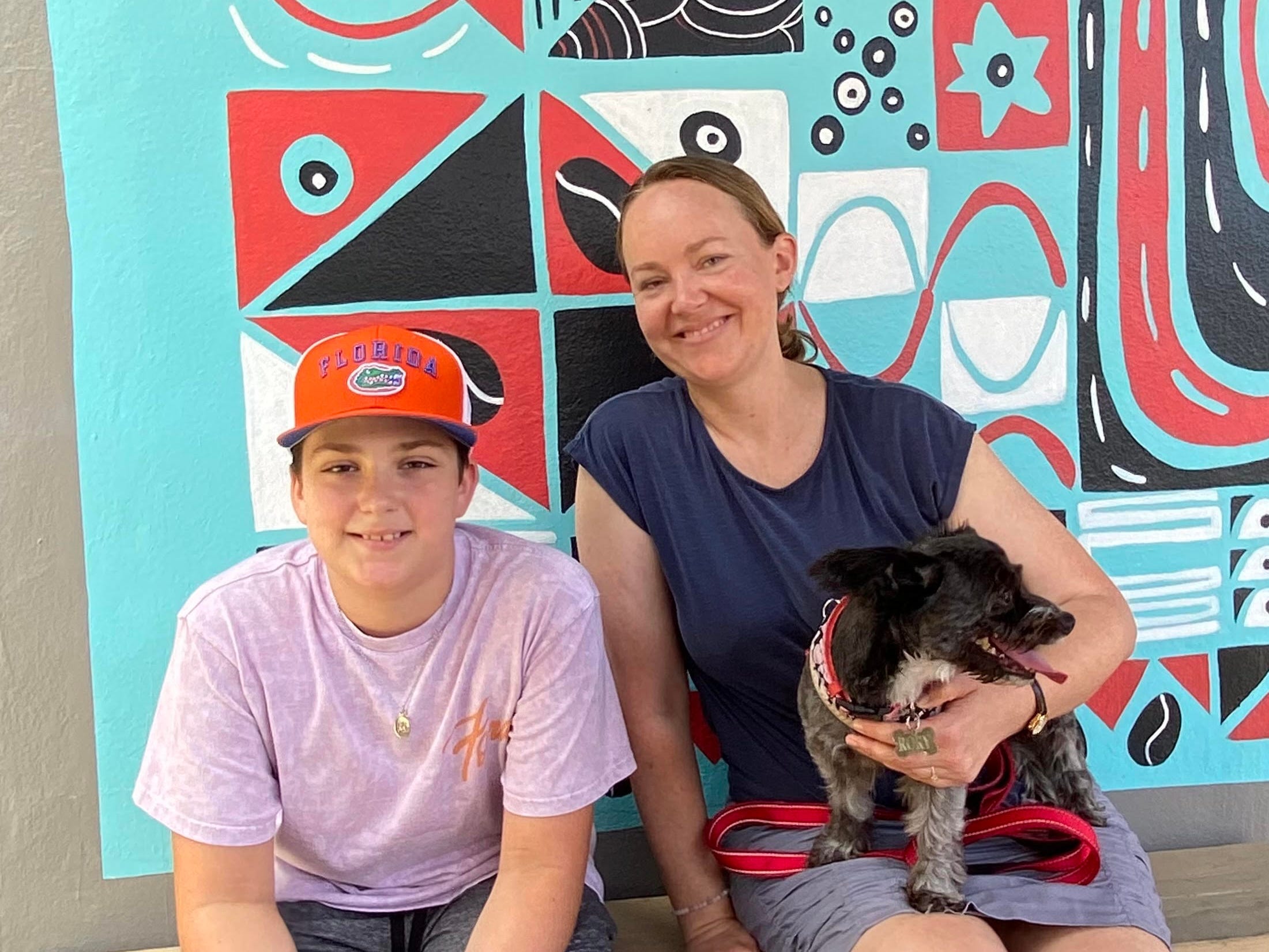The author and her son sitting on a bench with two dogs.
