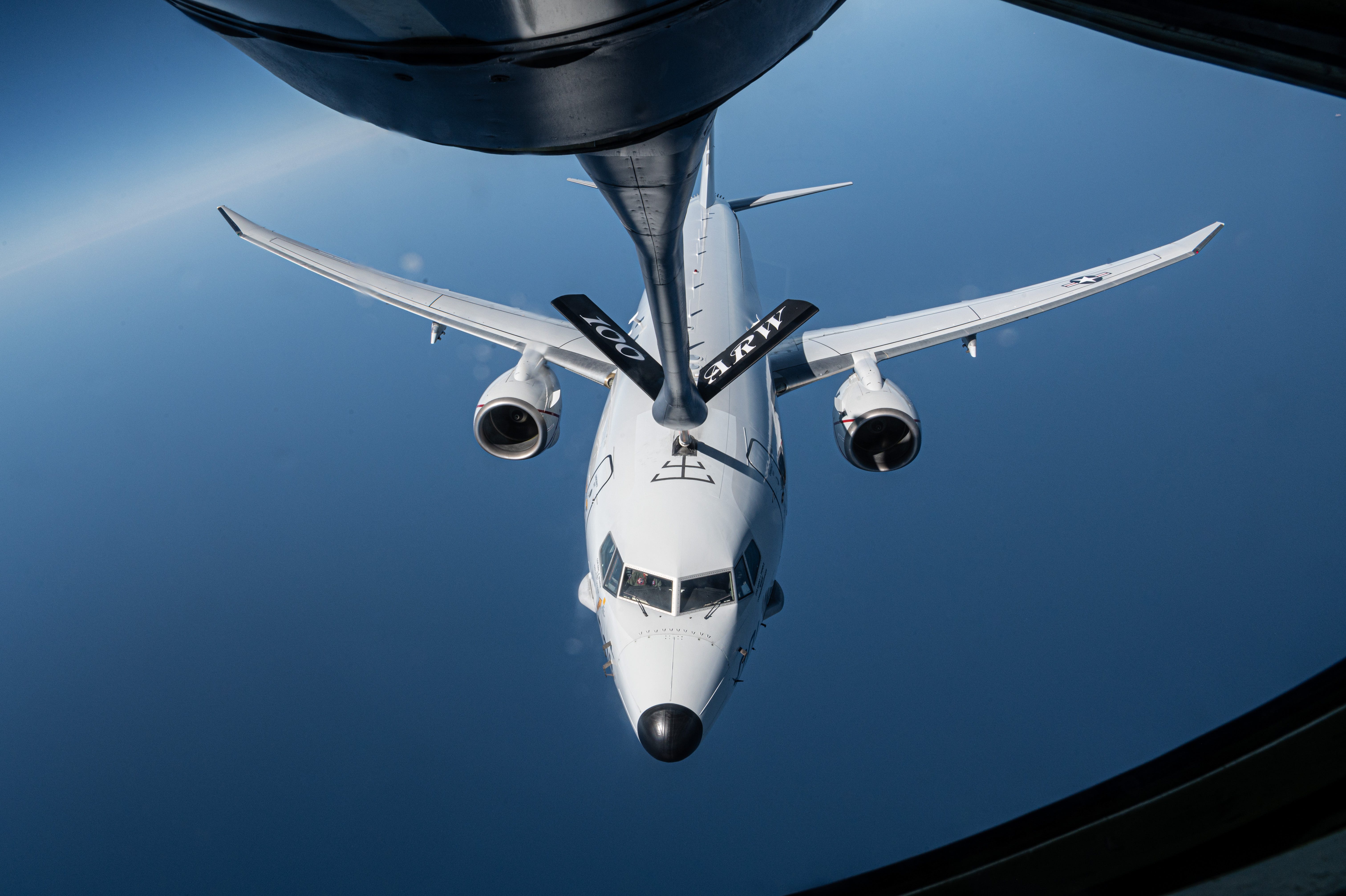A US Navy P-8 Poseidon receives fuel from a US Air Force KC-135 Stratotanker.