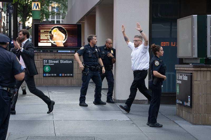 Office workers flee the area of an active shooter in Midtown Manhattan, Monday, June 28, 2025, in New York City.